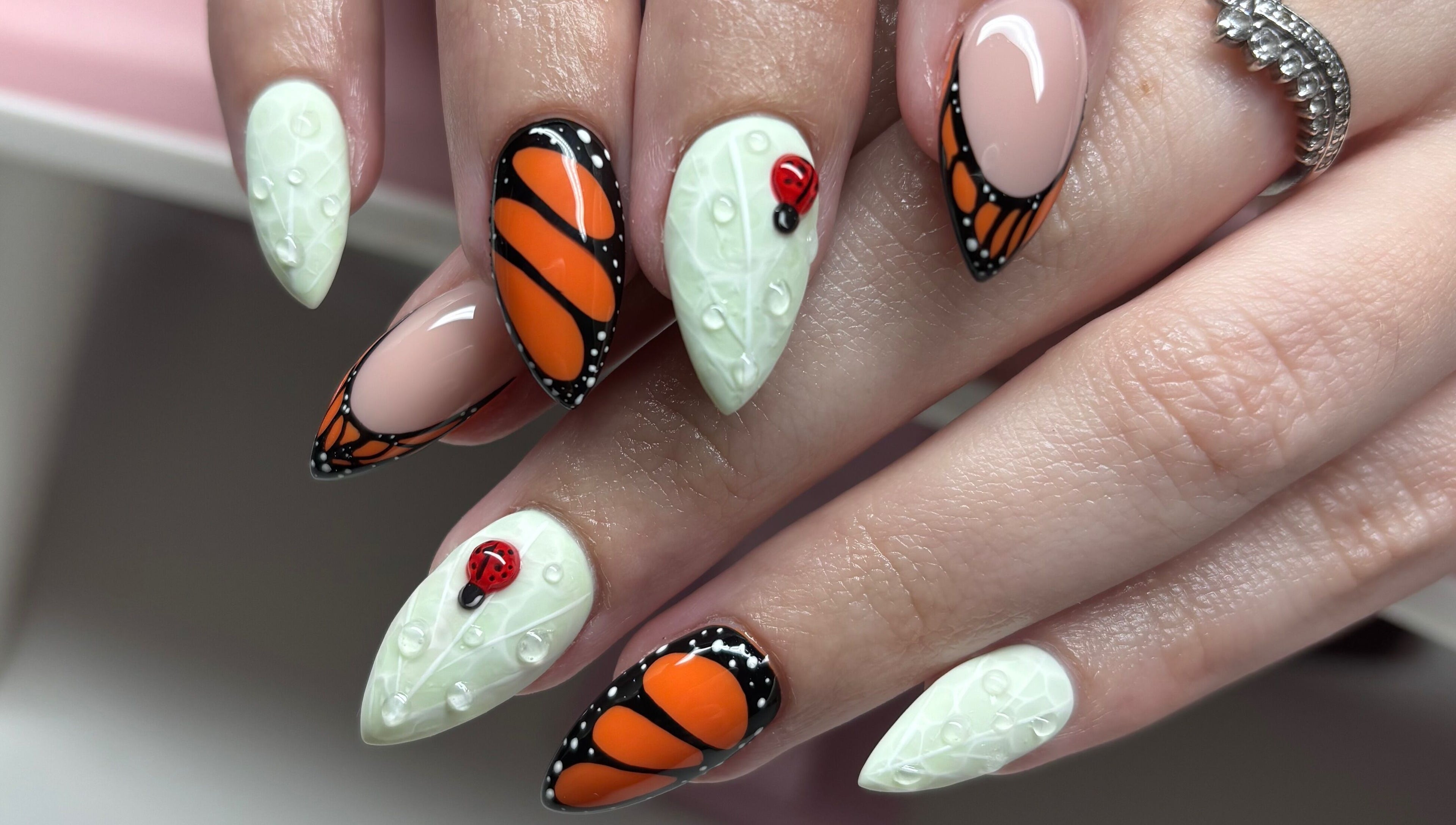 Artistic nail design at Clawsxtend Nails By Ivy, Bald Hills, Queensland, AU, featuring butterfly and ladybug accents.