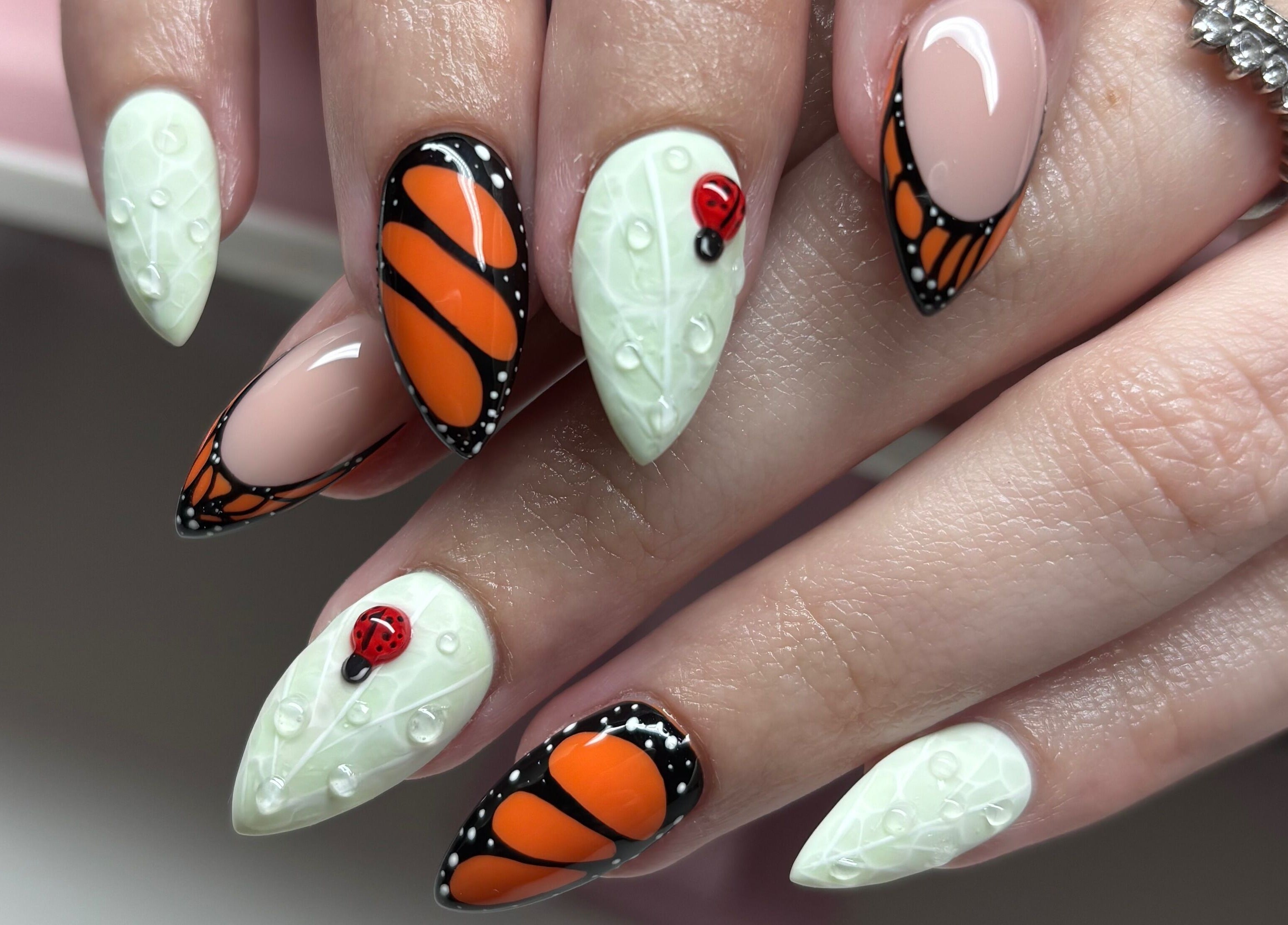 Artistic nail design at Clawsxtend Nails By Ivy, Bald Hills, Queensland, AU, featuring butterfly and ladybug accents.