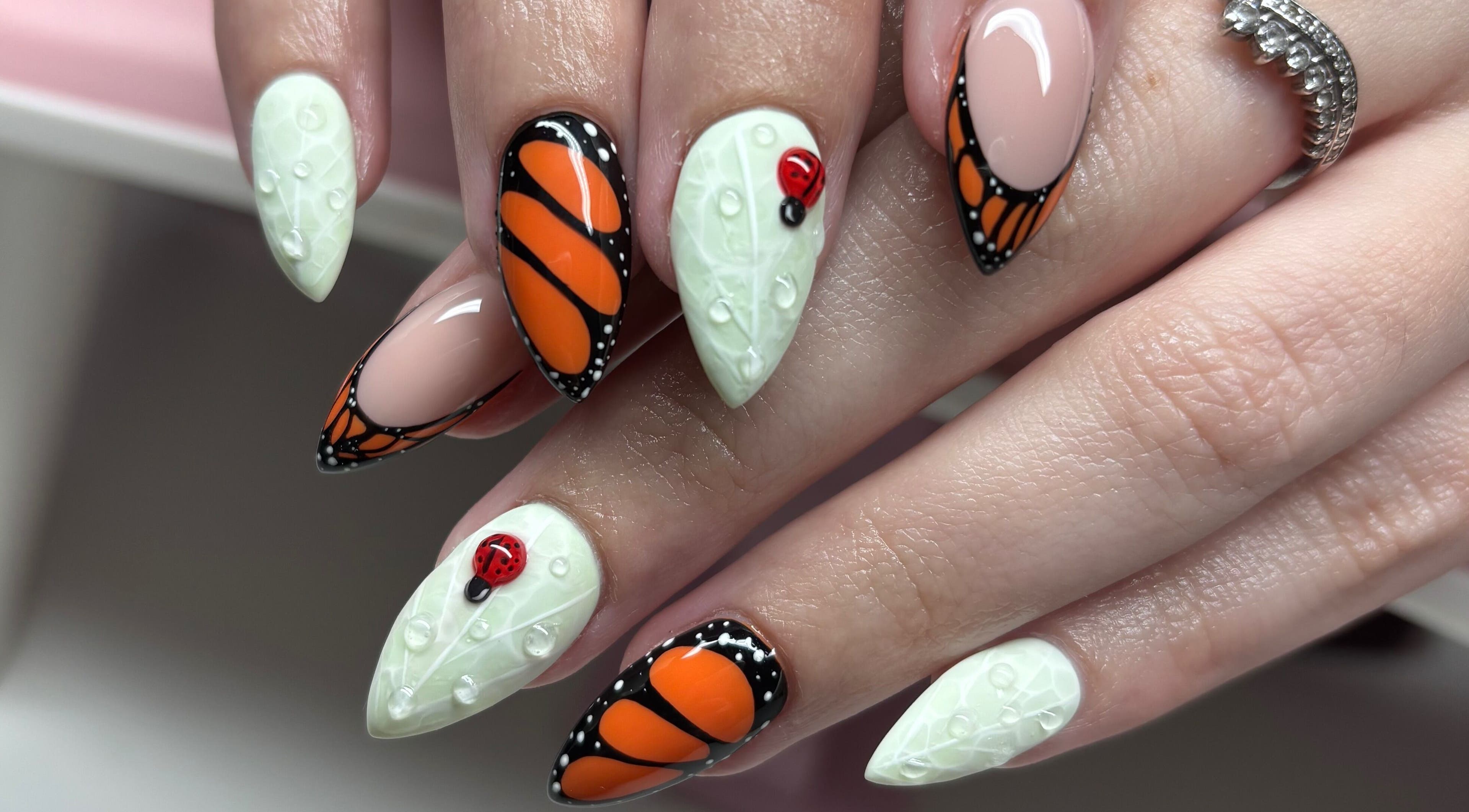 Artistic nail design at Clawsxtend Nails By Ivy, Bald Hills, Queensland, AU, featuring butterfly and ladybug accents.