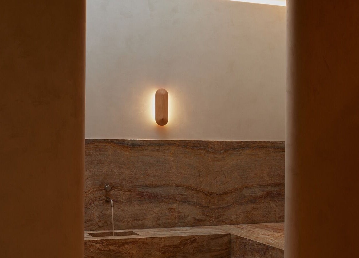 Elegant spa room at Comma Byron Bay, Byron Bay, New South Wales, AU with minimalist stone decor and soft lighting.