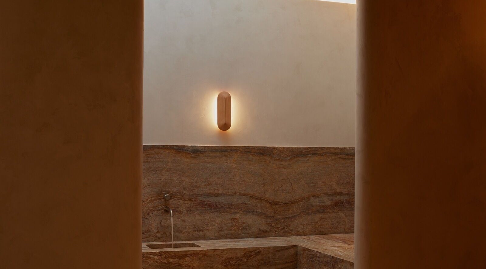 Elegant spa room at Comma Byron Bay, Byron Bay, New South Wales, AU with minimalist stone decor and soft lighting.