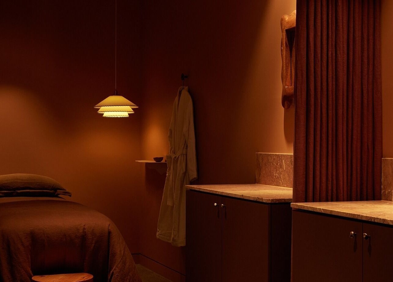 Spa treatment room at Comma Byron Bay, featuring ambient lighting, located in Byron Bay, New South Wales, AU.