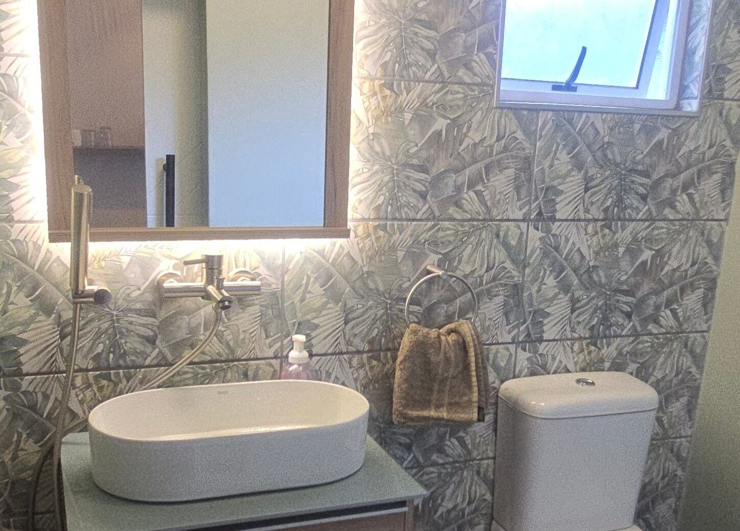 Elegant bathroom at Beauty by Kristy, Gqeberha, Eastern Cape, ZA with leafy tiles and modern fixtures.