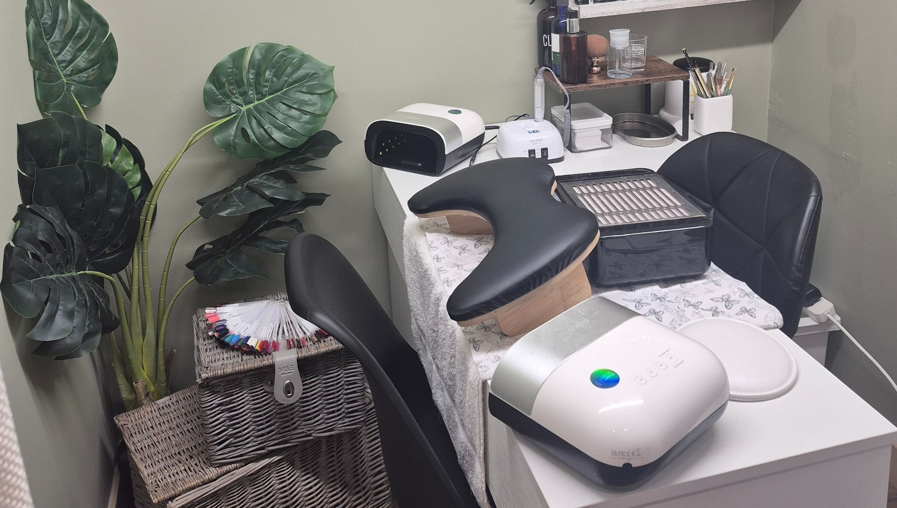 Cozy beauty station at Liuda’s Massage and Beauty in Alexandria, Scotland, GB, with lush greenery and nail tools.