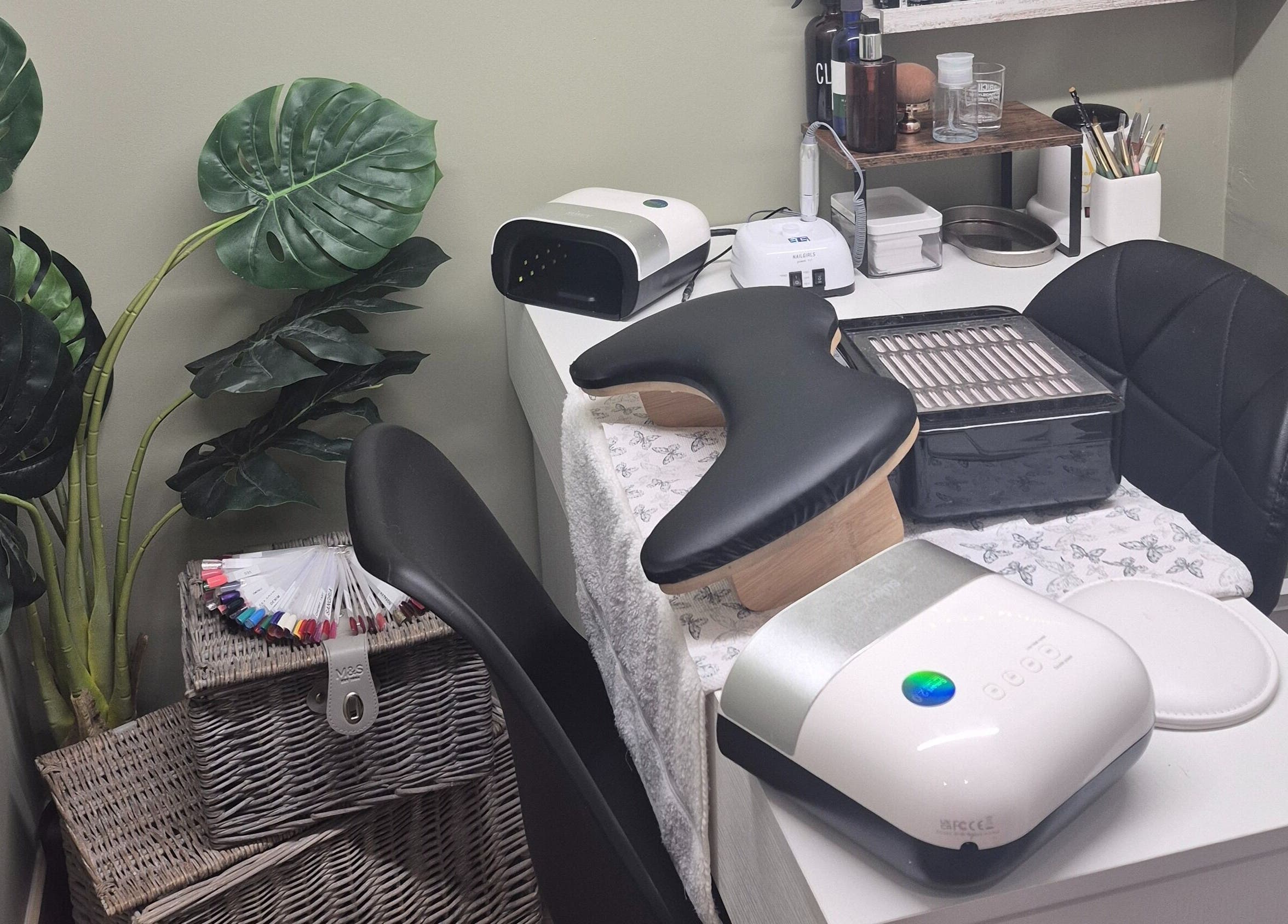 Cozy beauty station at Liuda’s Massage and Beauty in Alexandria, Scotland, GB, with lush greenery and nail tools.