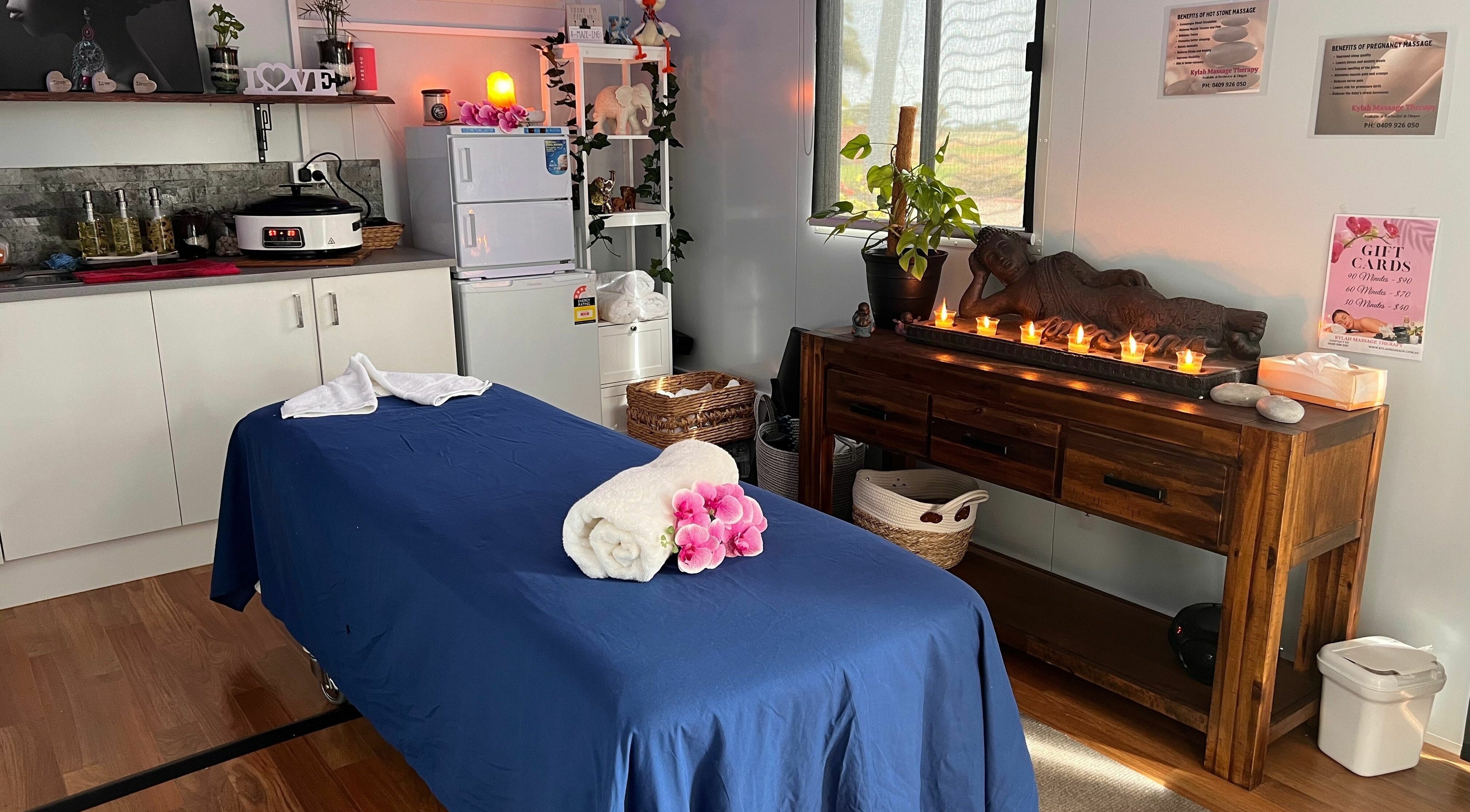 Cozy massage room at Kylah Massage - Rochester Clinic, Diggora, Victoria, AU with candles and orchid decor.
