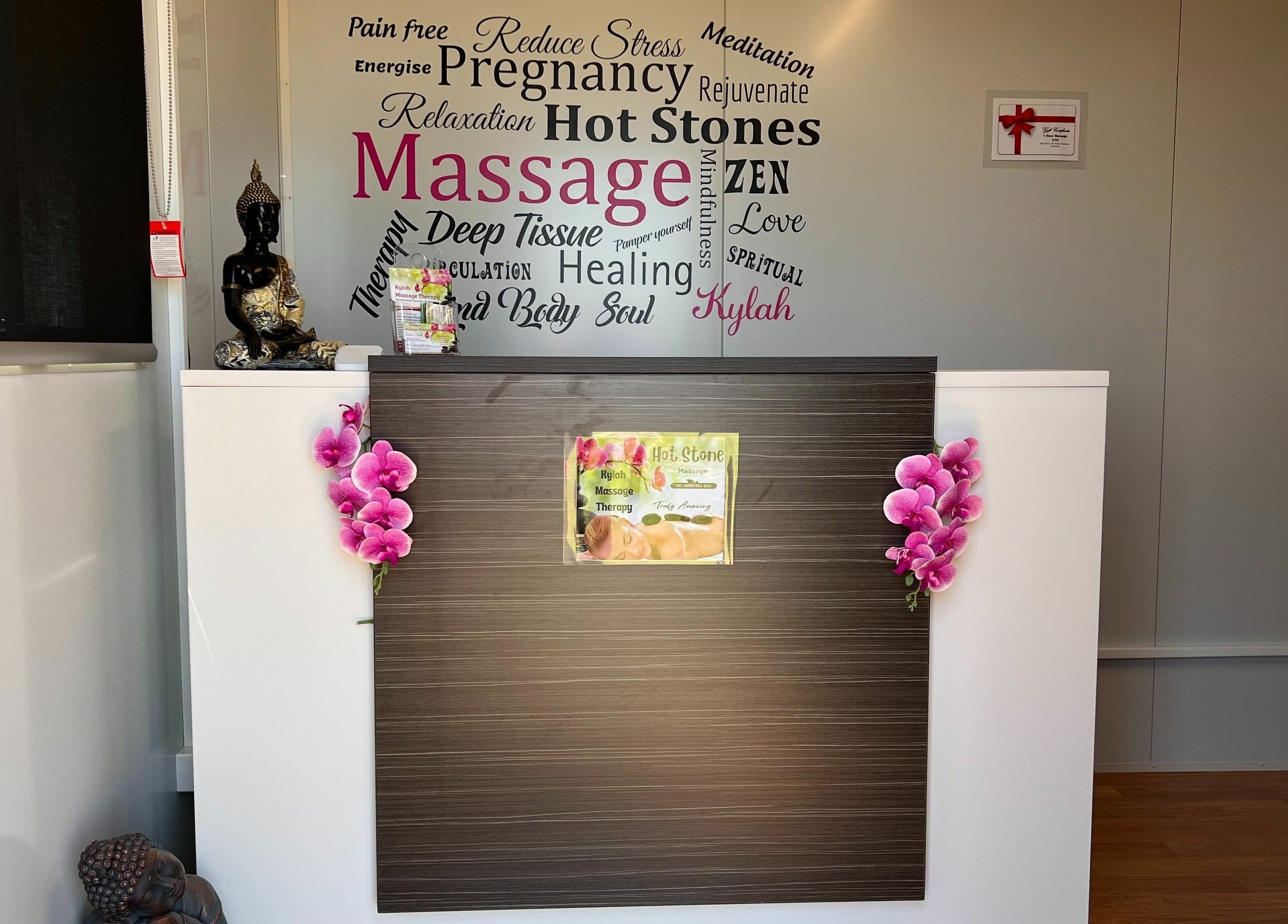 Reception area at Kylah Massage - Rochester Clinic in Diggora, Victoria, AU with Buddha statuette and orchids.