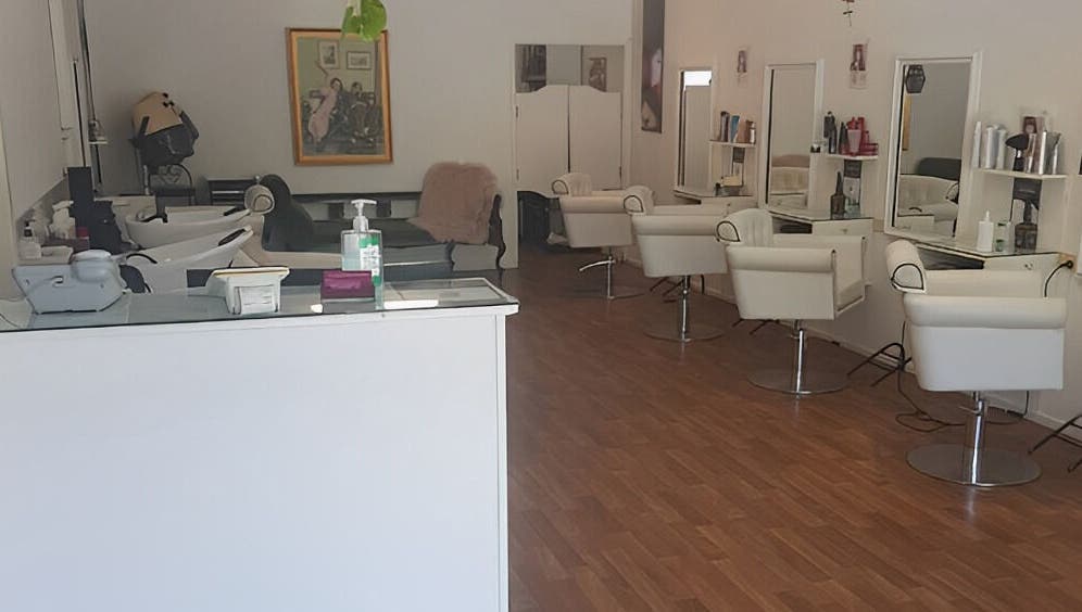 Interior of Execute Hair, Beauty & Barbering in Kewarra Beach, Queensland, AU, featuring modern chairs and mirrors.