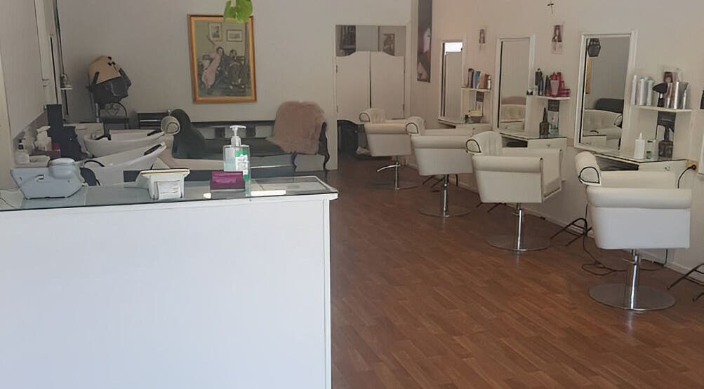 Interior of Execute Hair, Beauty & Barbering in Kewarra Beach, Queensland, AU, featuring modern chairs and mirrors.