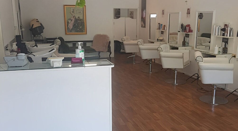 Interior of Execute Hair, Beauty & Barbering in Kewarra Beach, Queensland, AU, featuring modern chairs and mirrors.