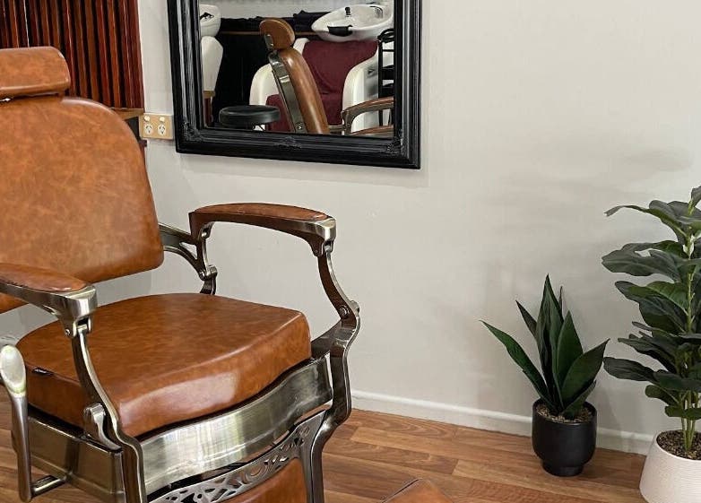 Elegant barber chair at Execute Hair, Beauty & Barbering, Kewarra Beach, Queensland, AU with chic salon decor.