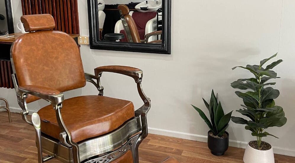 Elegant barber chair at Execute Hair, Beauty & Barbering, Kewarra Beach, Queensland, AU with chic salon decor.