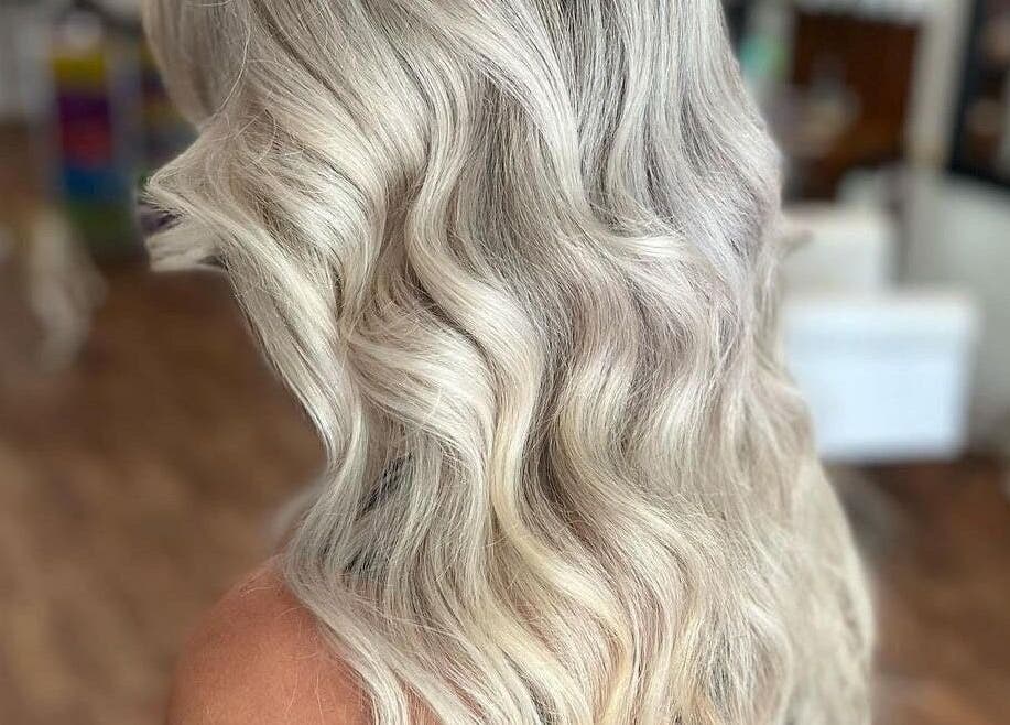Elegant wavy blonde hairstyle at Execute Hair, Beauty & Barbering, Kewarra Beach, Queensland, AU.