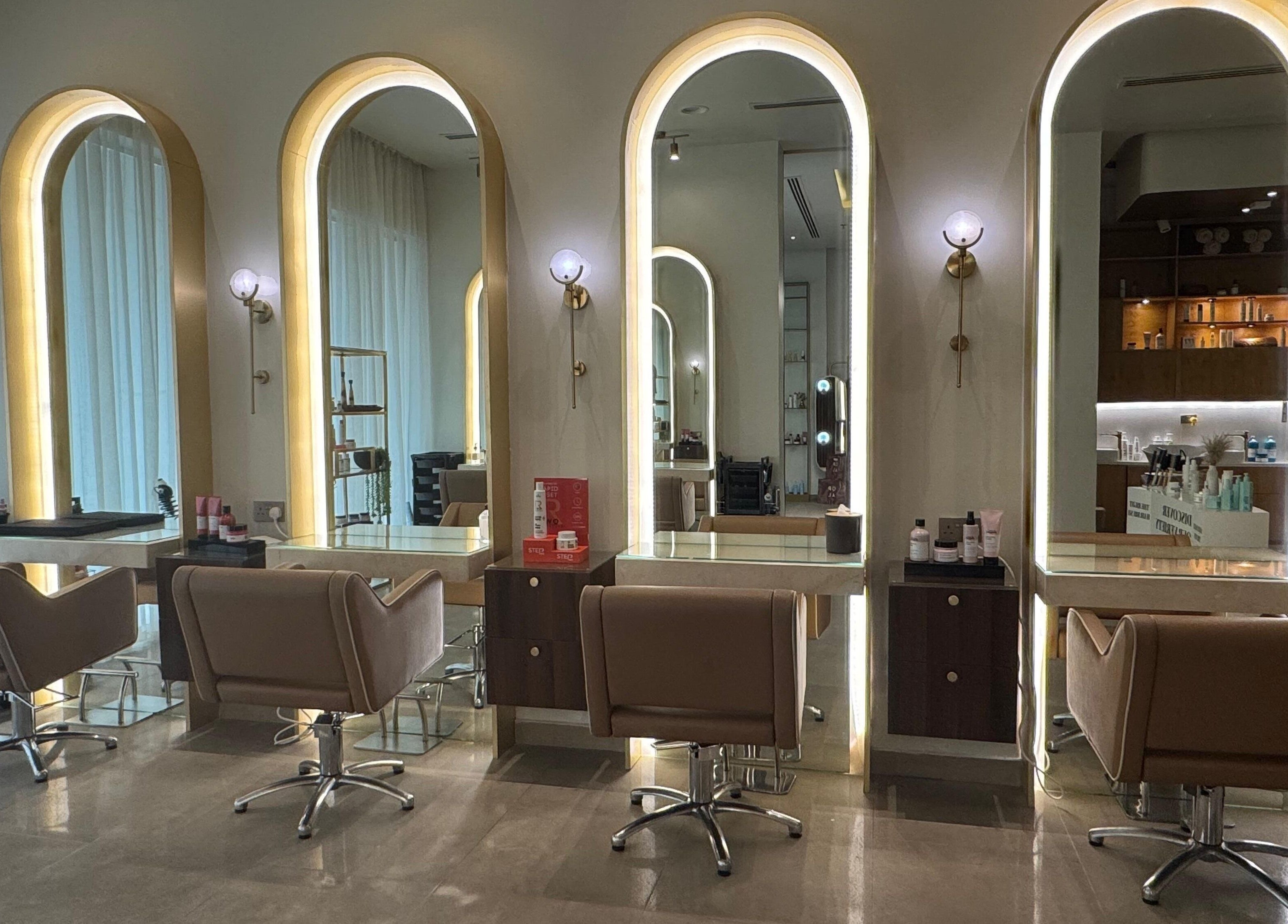 Interior of Abreez Beauty Salon in Sharjah featuring elegant mirrors and styling chairs.