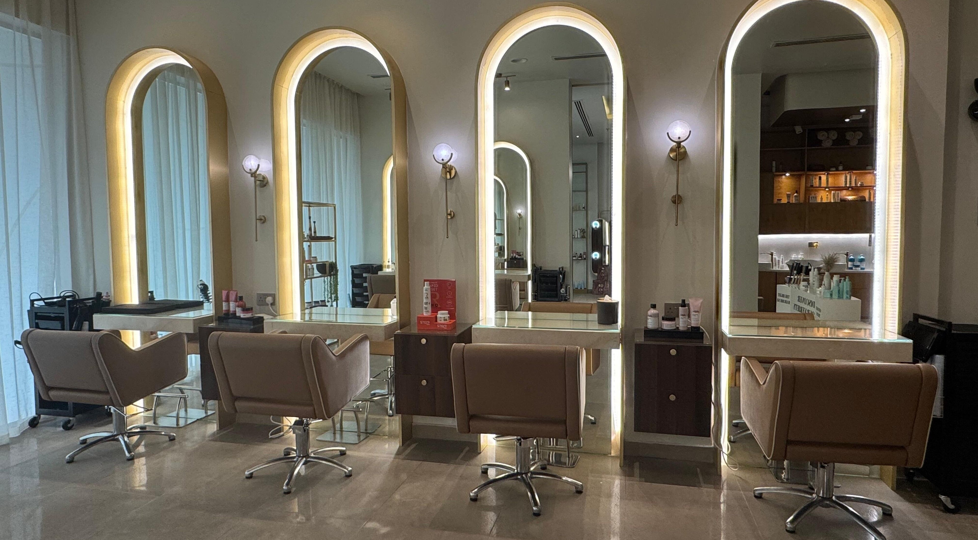 Interior of Abreez Beauty Salon in Sharjah featuring elegant mirrors and styling chairs.