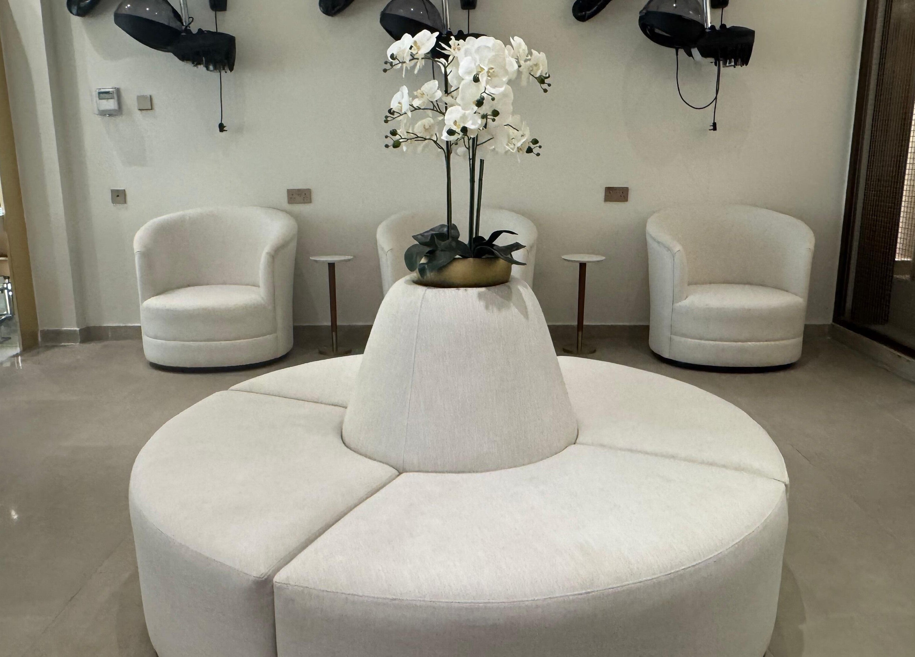 Luxurious seating area at Abreez Beauty Salon in Sharjah, Sharjah, AE featuring elegant white decor.