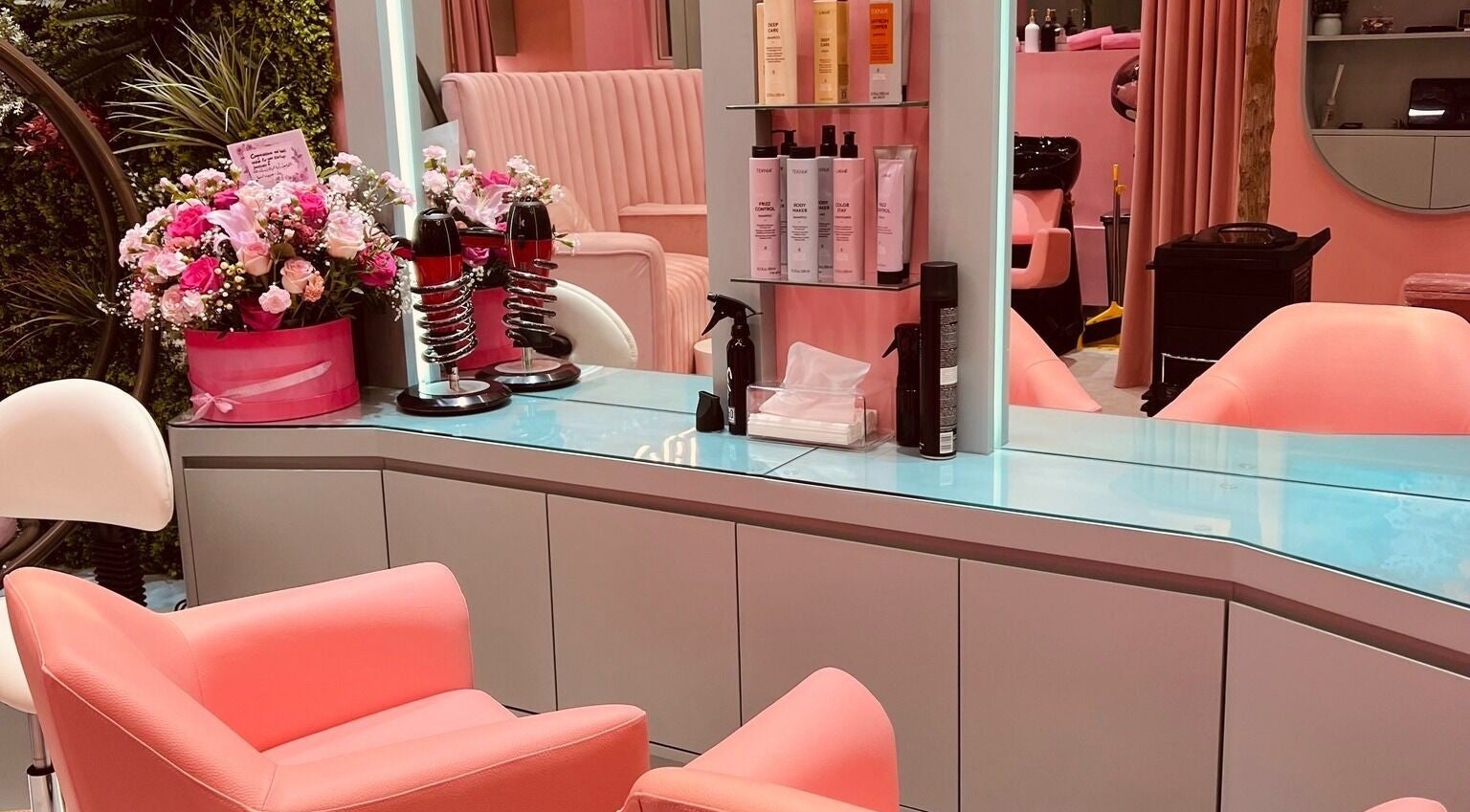 Modern beauty salon interior with pink chairs and floral decor at La Colmena Beauty Hive, Dubai, Dubai, AE.