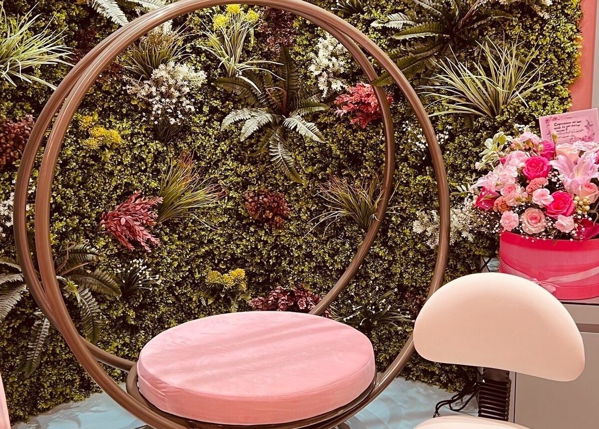 Elegant beauty salon chair with floral wall at La Colmena Beauty Hive, Dubai, Dubai, AE.