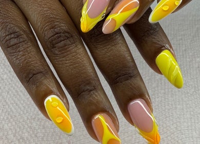 Vibrant nail art design at Spa Bijou in George Town, George Town, KY showcases yellow and orange shades.
