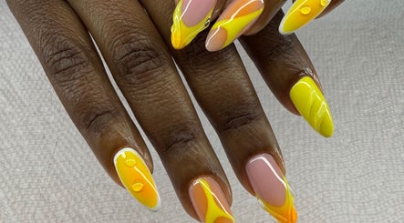 Vibrant nail art design at Spa Bijou in George Town, George Town, KY showcases yellow and orange shades.