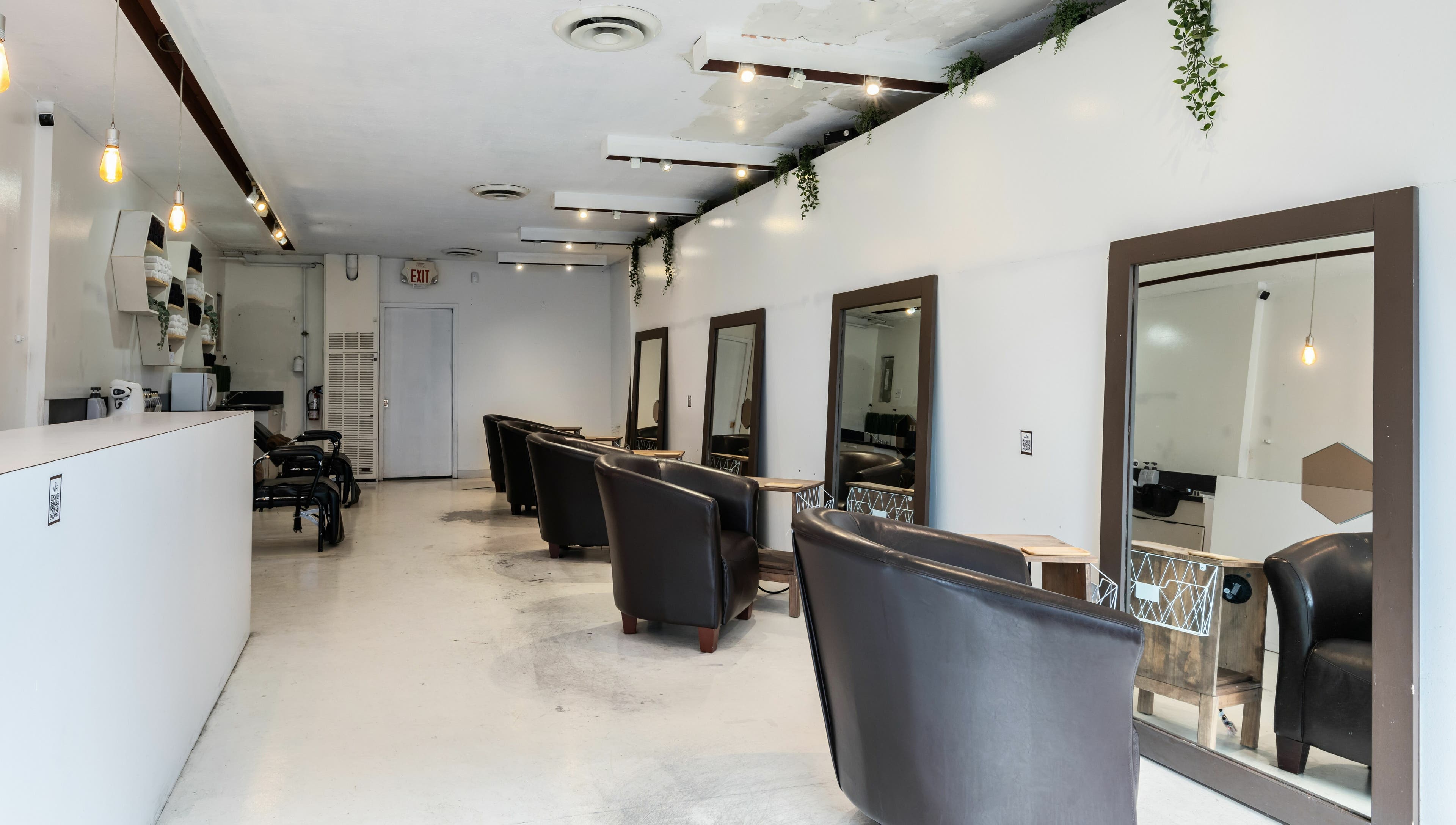 Inside Hive Hair Spa at Oak in Vancouver, BC, CA. Modern decor with styling stations and leather chairs.