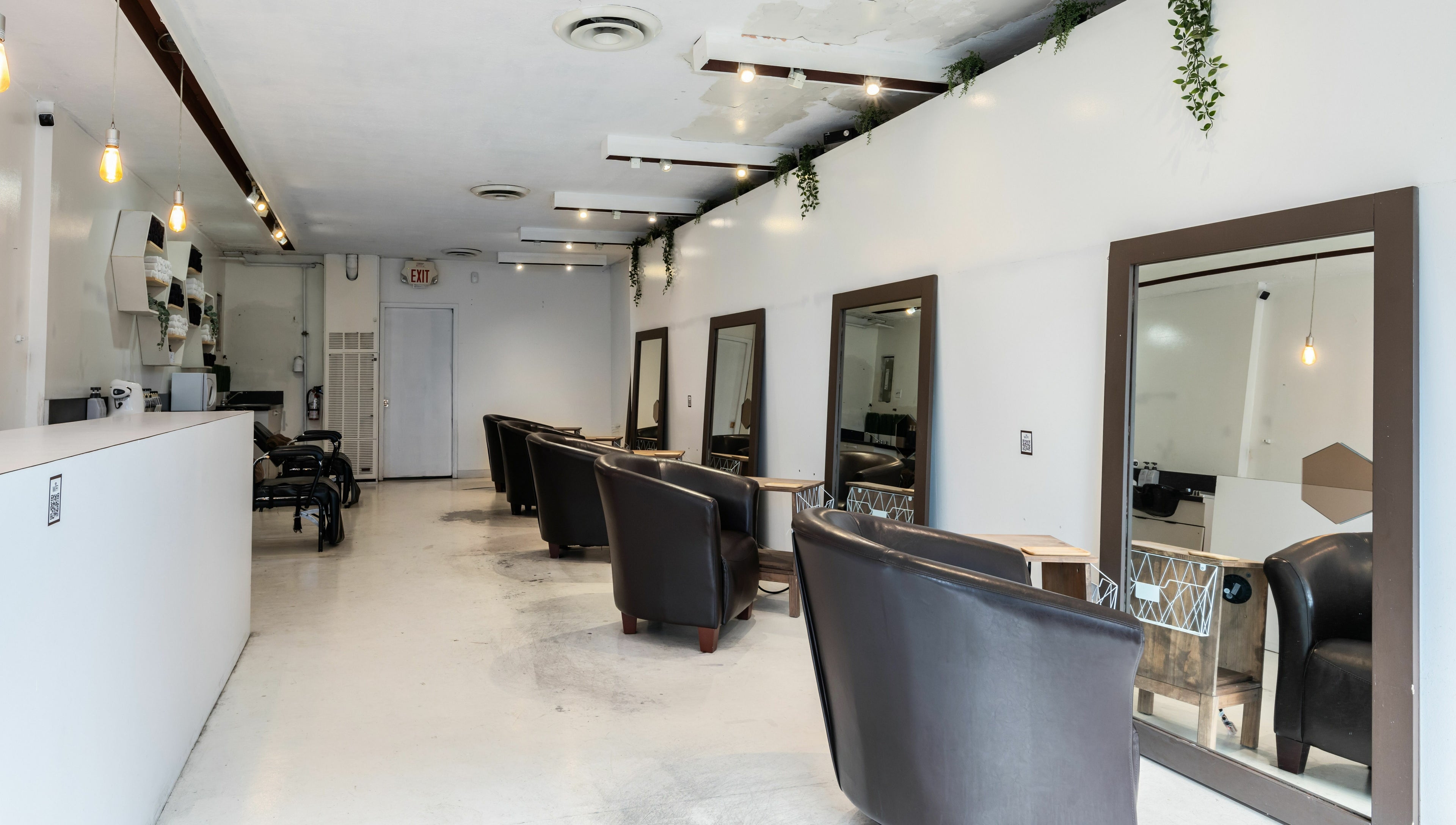 Inside Hive Hair Spa at Oak in Vancouver, BC, CA. Modern decor with styling stations and leather chairs.