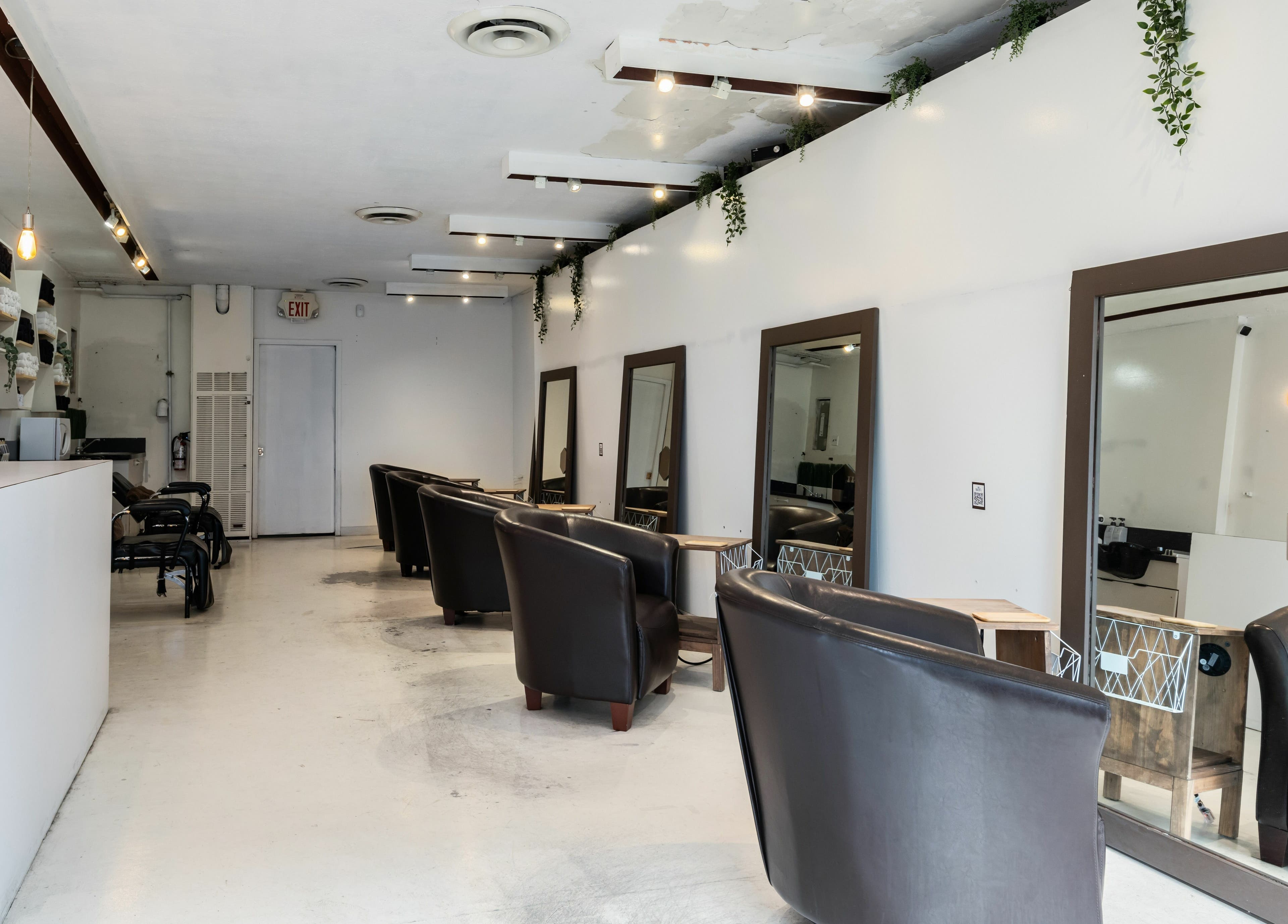 Inside Hive Hair Spa at Oak in Vancouver, BC, CA. Modern decor with styling stations and leather chairs.