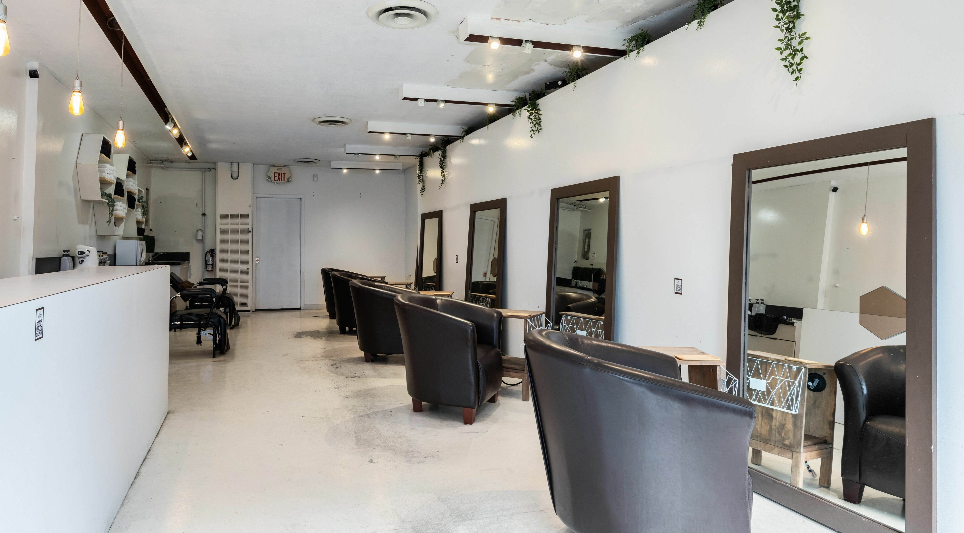Inside Hive Hair Spa at Oak in Vancouver, BC, CA. Modern decor with styling stations and leather chairs.