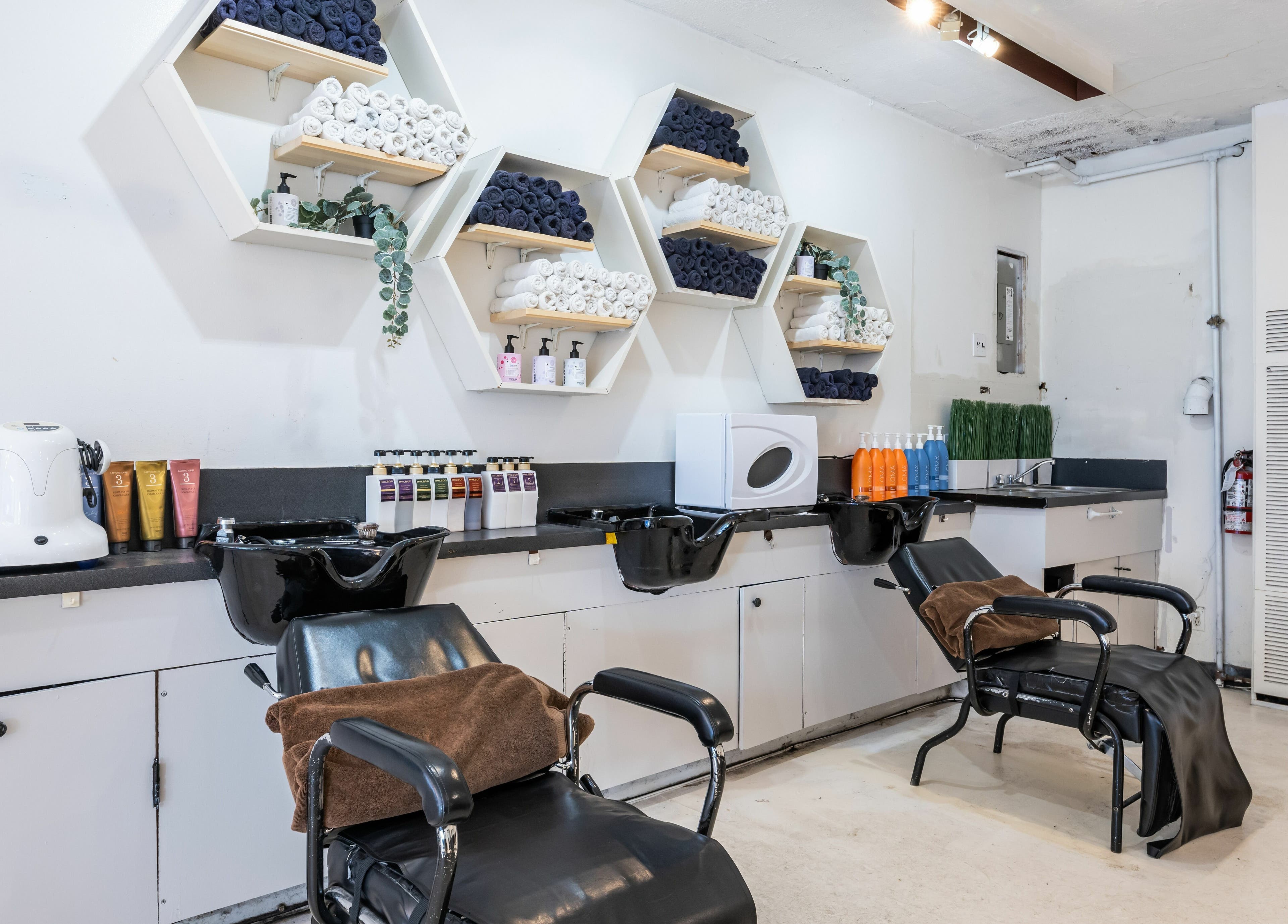 Modern styling stations at Hive Hair Spa at Oak in Vancouver, British Columbia, CA, showcasing sleek design and elegance.