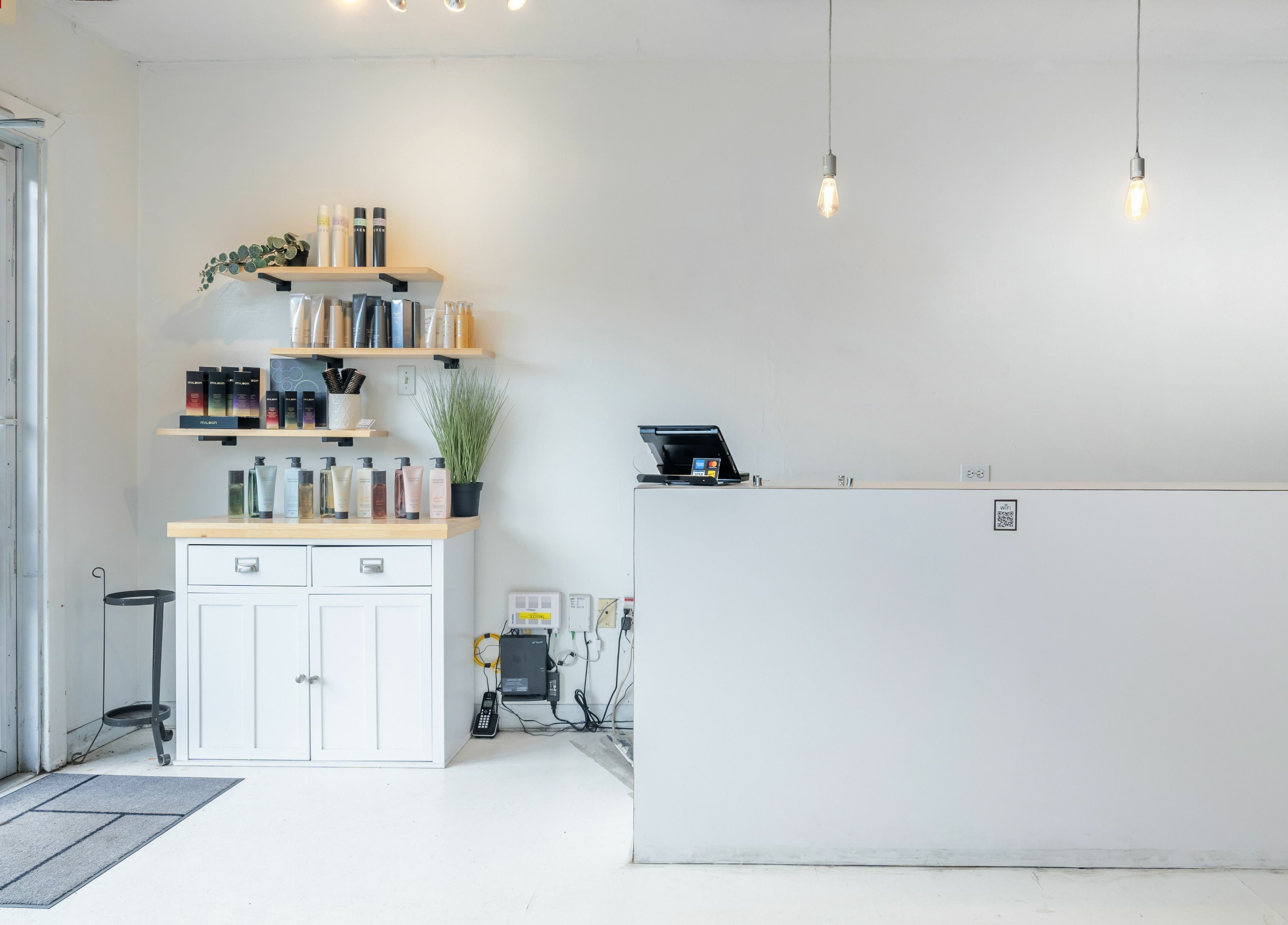Reception area of Hive Hair Spa at Oak, Vancouver, British Columbia, CA with product shelves and modern decor.
