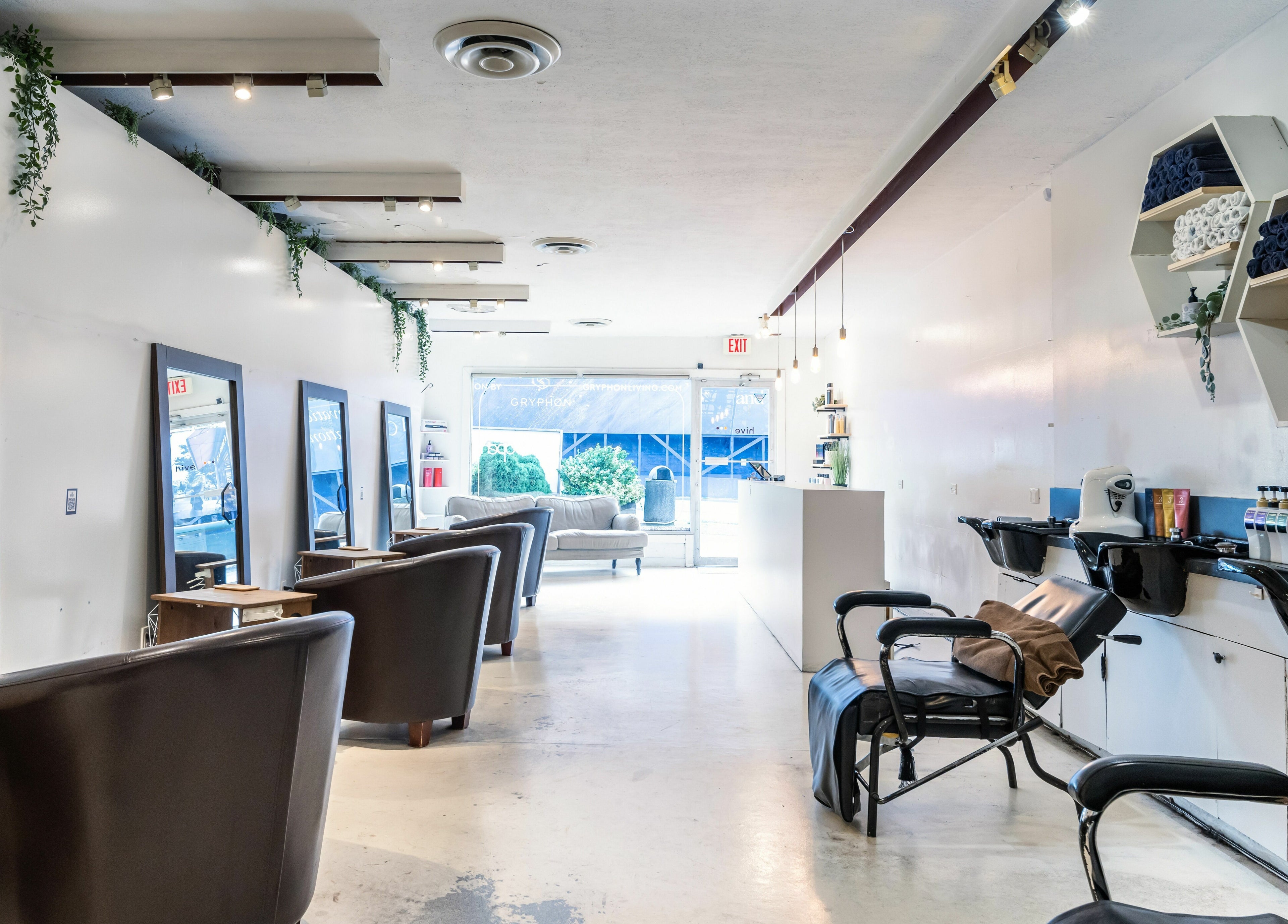 Chic interior of Hive Hair Spa at Oak in Vancouver, BC, showcasing cozy chairs and sleek design.