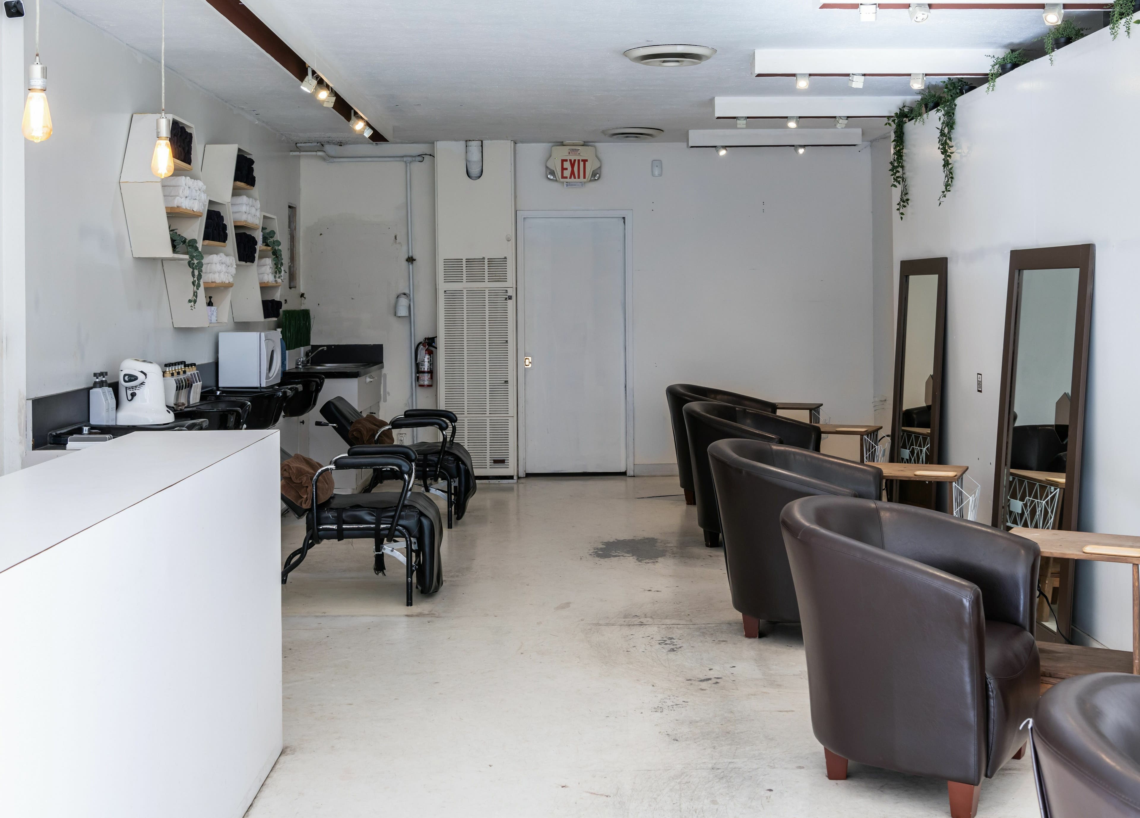 Modern salon interior at Hive Hair Spa at Oak in Vancouver, British Columbia, CA with mirrors and chairs.