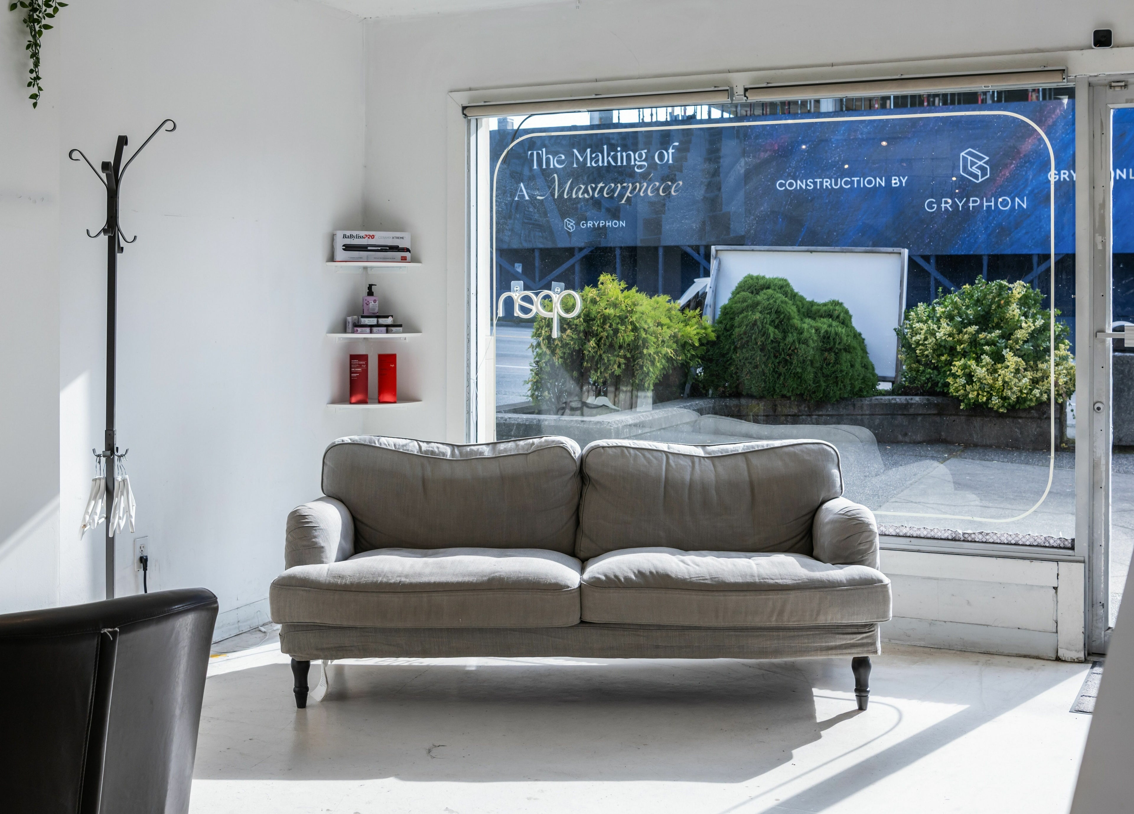 Inviting interior of Hive Hair Spa at Oak in Vancouver, BC, featuring a cozy couch and stylish decor.