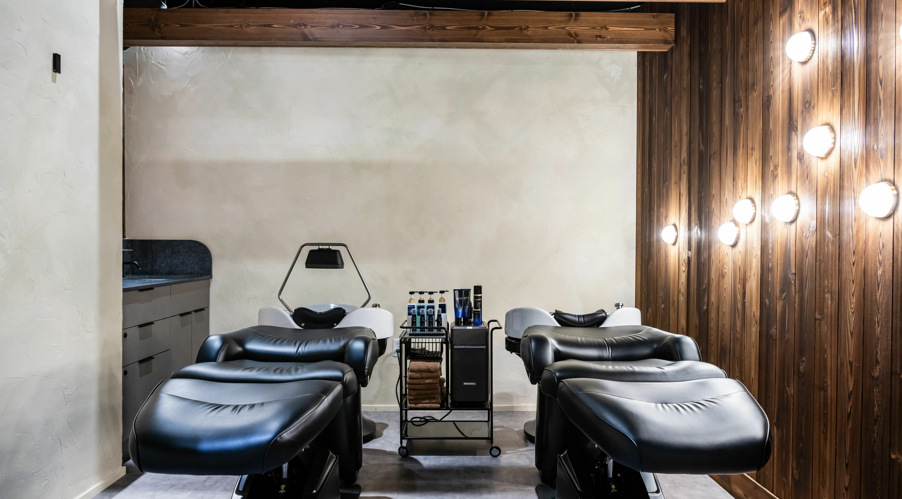 Sleek salon chairs at Hive Hair Spa | Broadway in Vancouver, British Columbia, CA for ultimate relaxation.