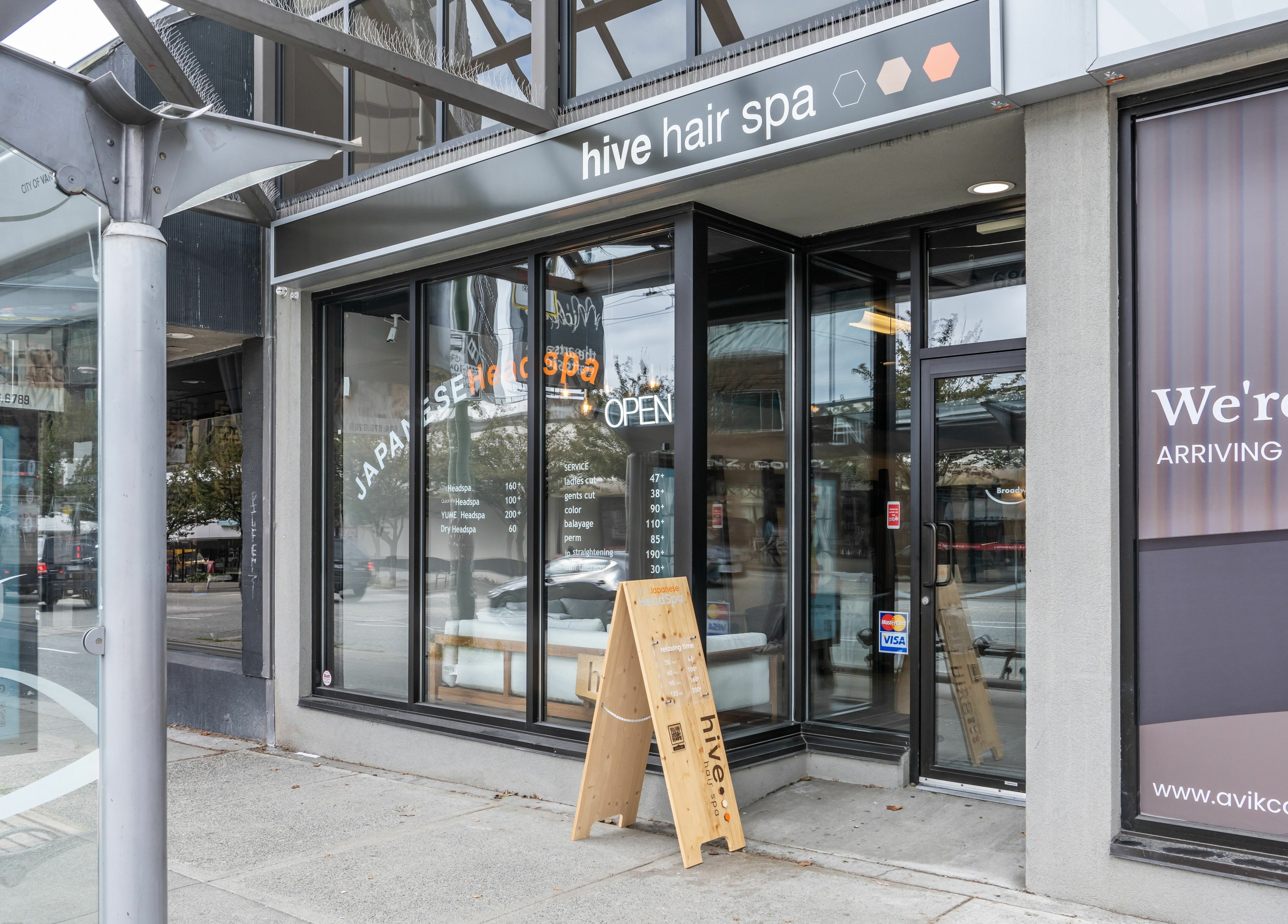 Hive Hair Spa | Broadway entrance in Vancouver, British Columbia, CA with elegant glass windows.