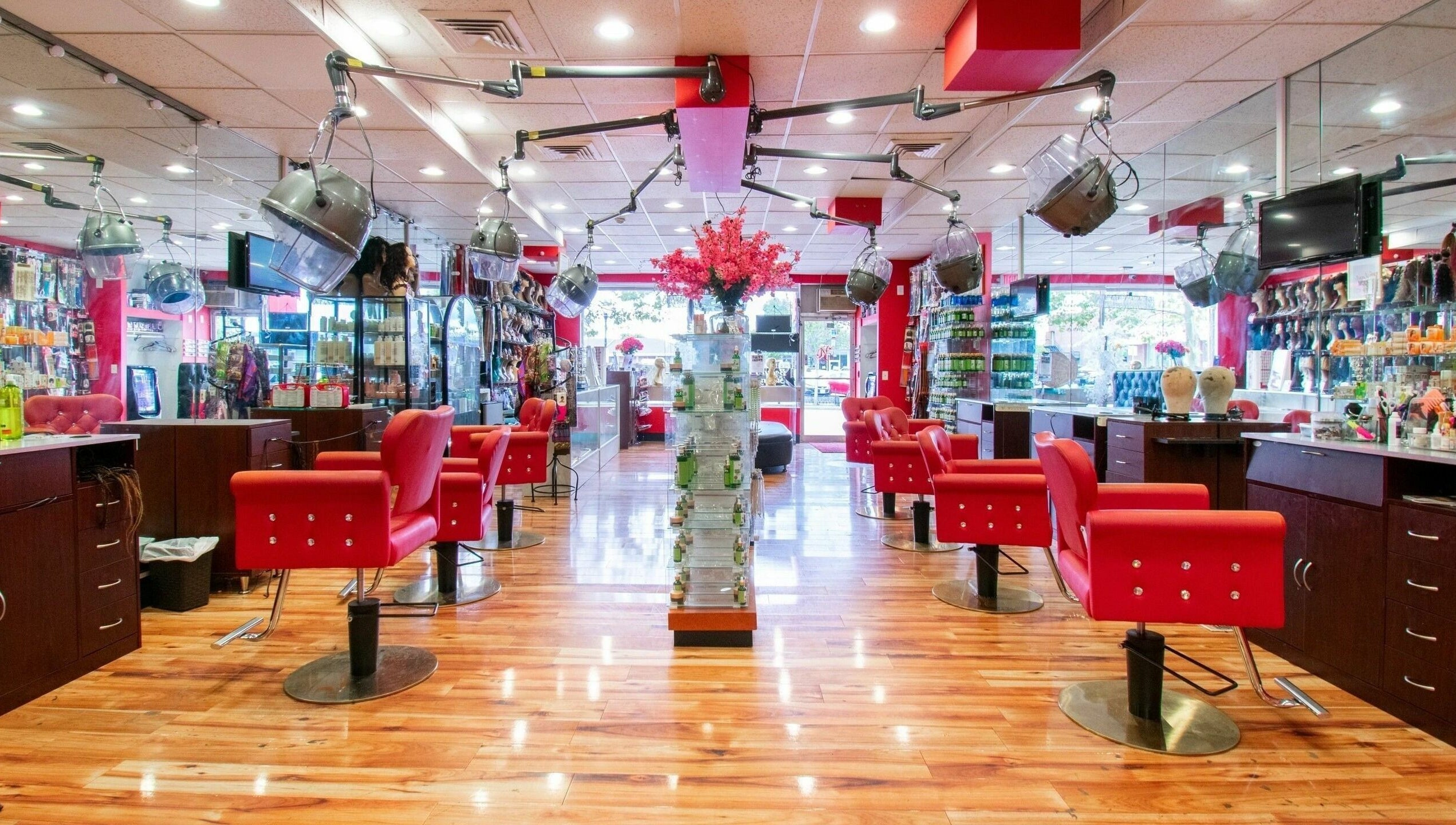 Interior view of NADEGE CREATION - RANDOLPH in Randolph, Massachusetts, US with red chairs and warm lighting.