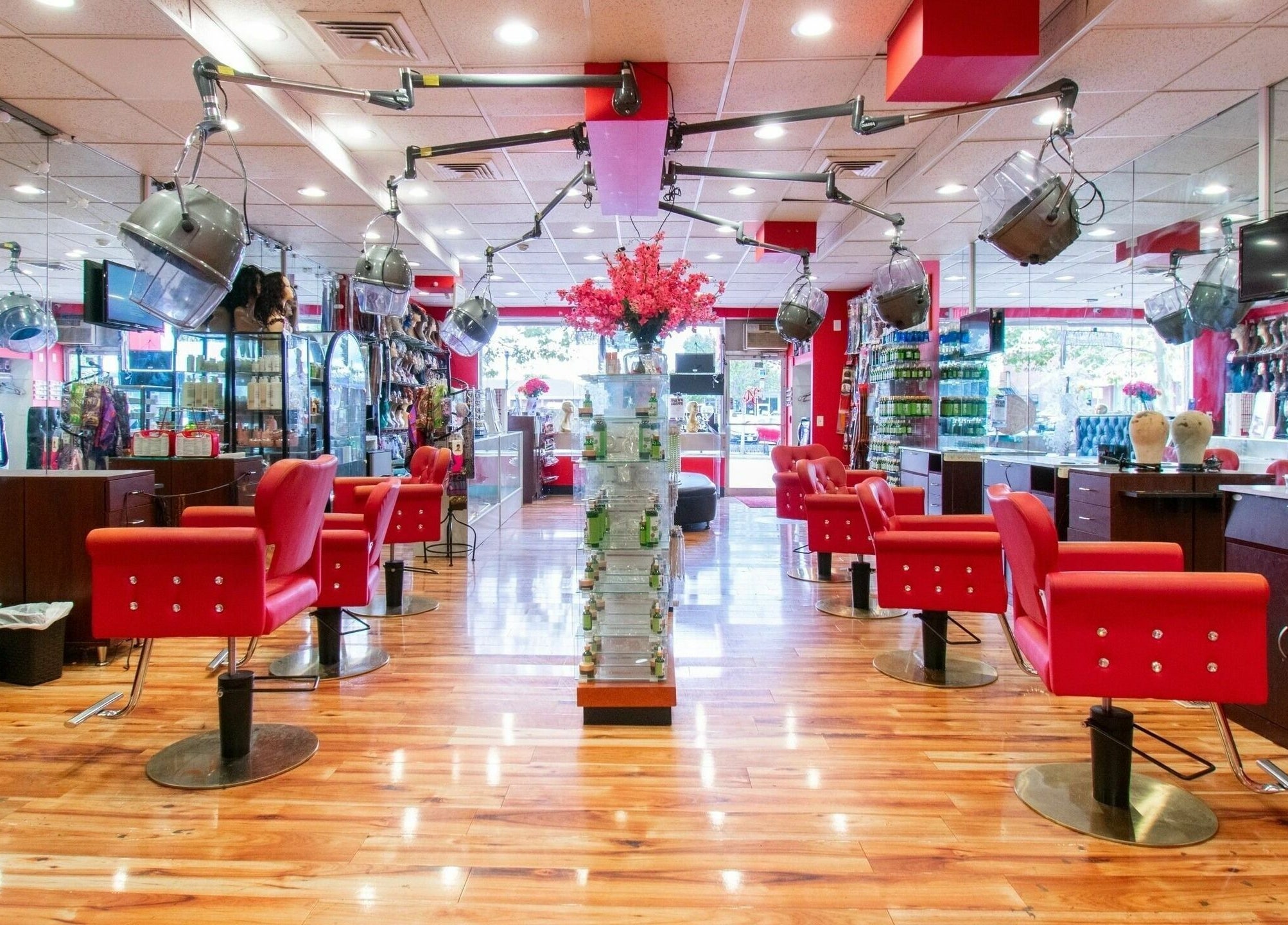 Interior view of NADEGE CREATION - RANDOLPH in Randolph, Massachusetts, US with red chairs and warm lighting.