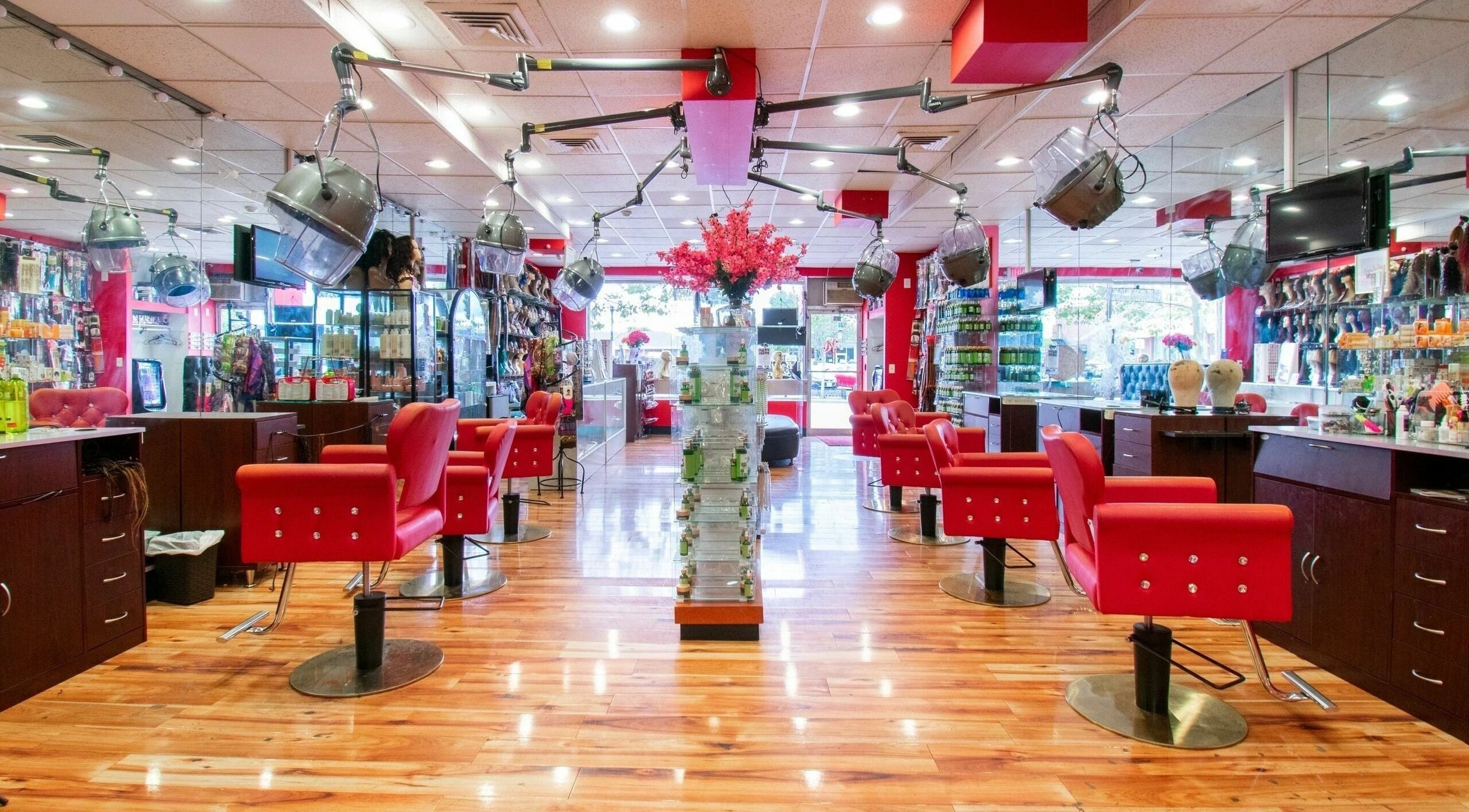 Interior view of NADEGE CREATION - RANDOLPH in Randolph, Massachusetts, US with red chairs and warm lighting.