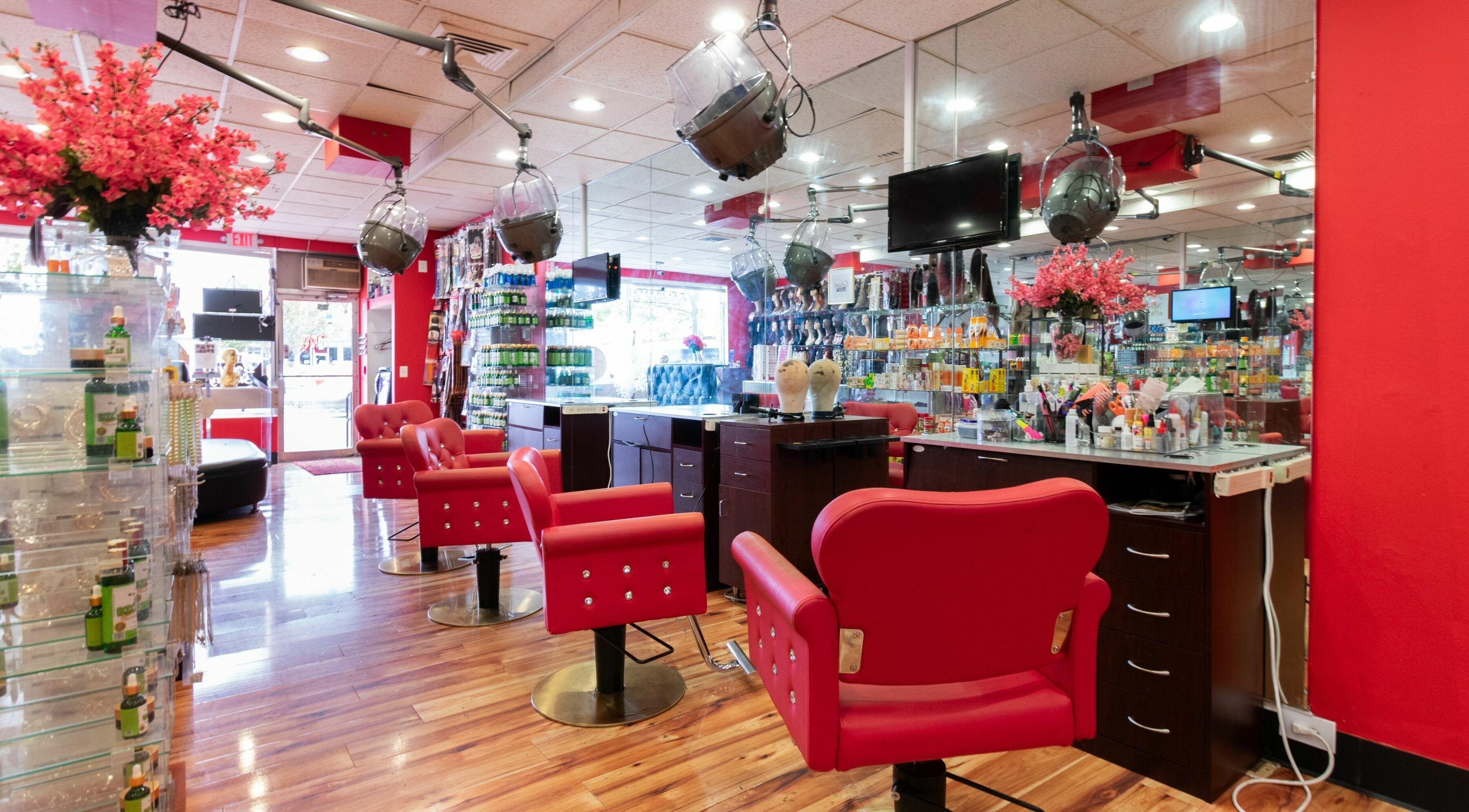 Vibrant salon interior with red accents at Nadege Creation - SOUTH SHORE PLAZA, Braintree, Massachusetts, US.