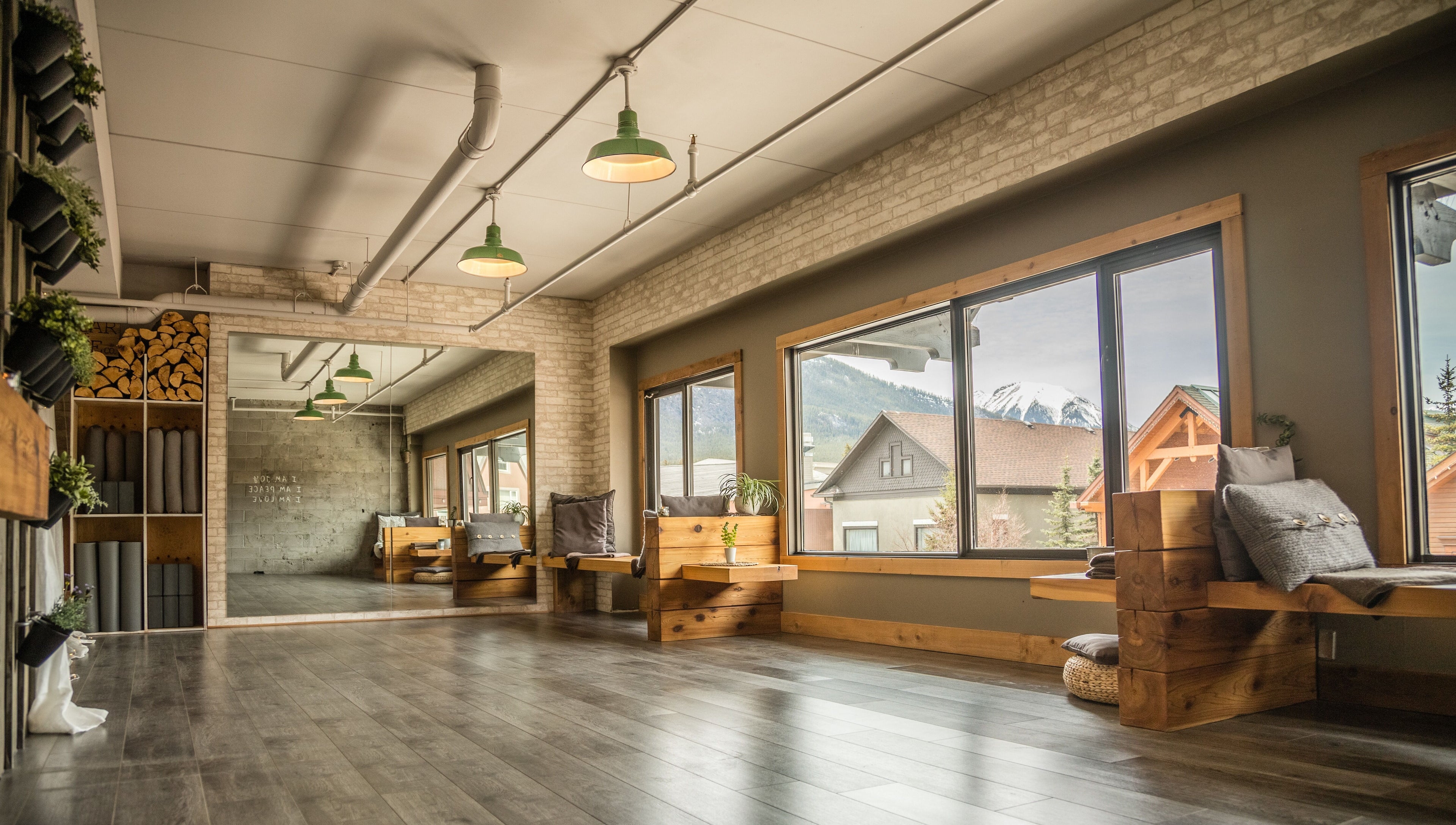 Bright yoga studio at Cedar & Sage Co, Banff, Alberta, CA with mountain views and natural wood accents.