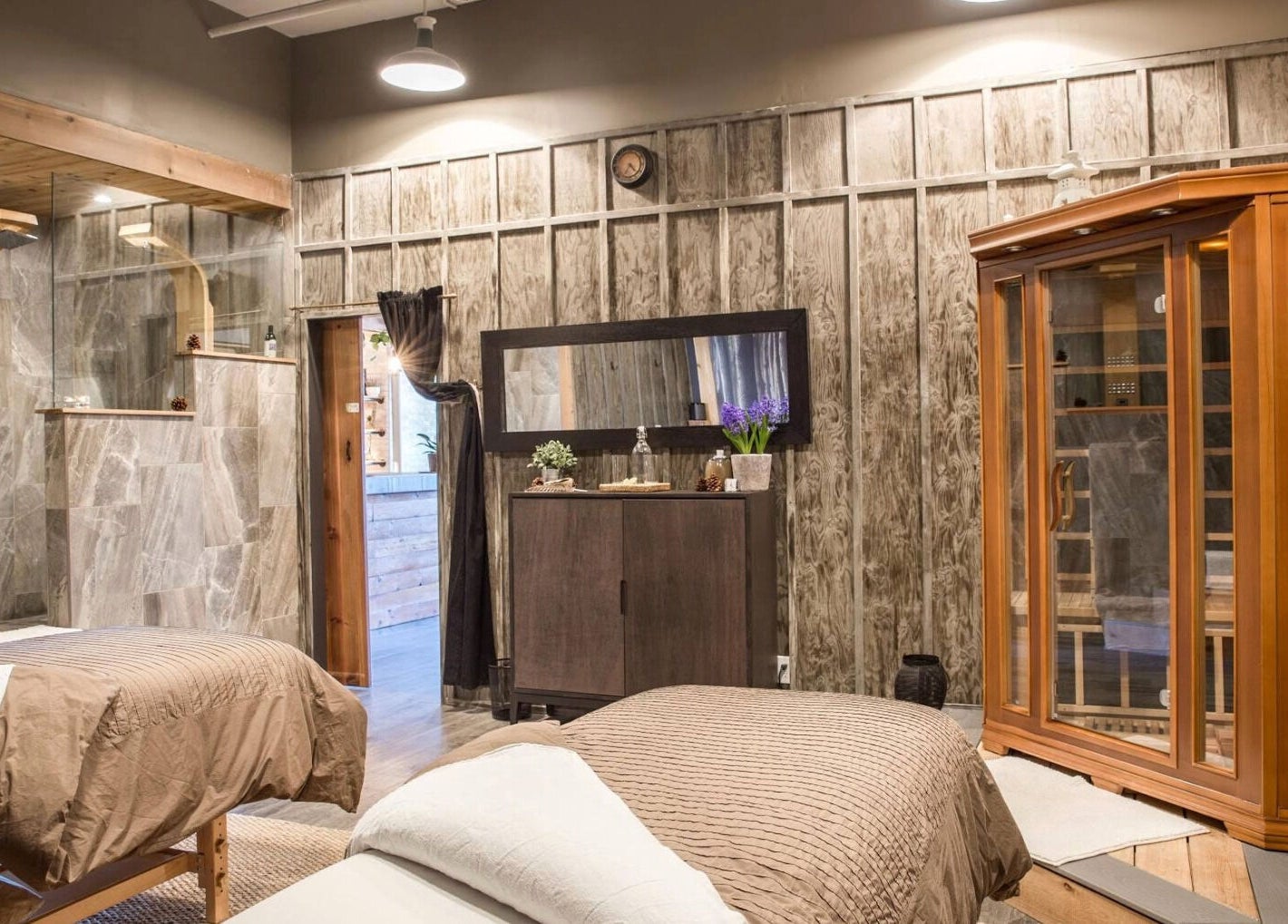 Relaxing spa room at Cedar & Sage Co in Banff, Alberta, CA, featuring massage tables and luxurious decor.