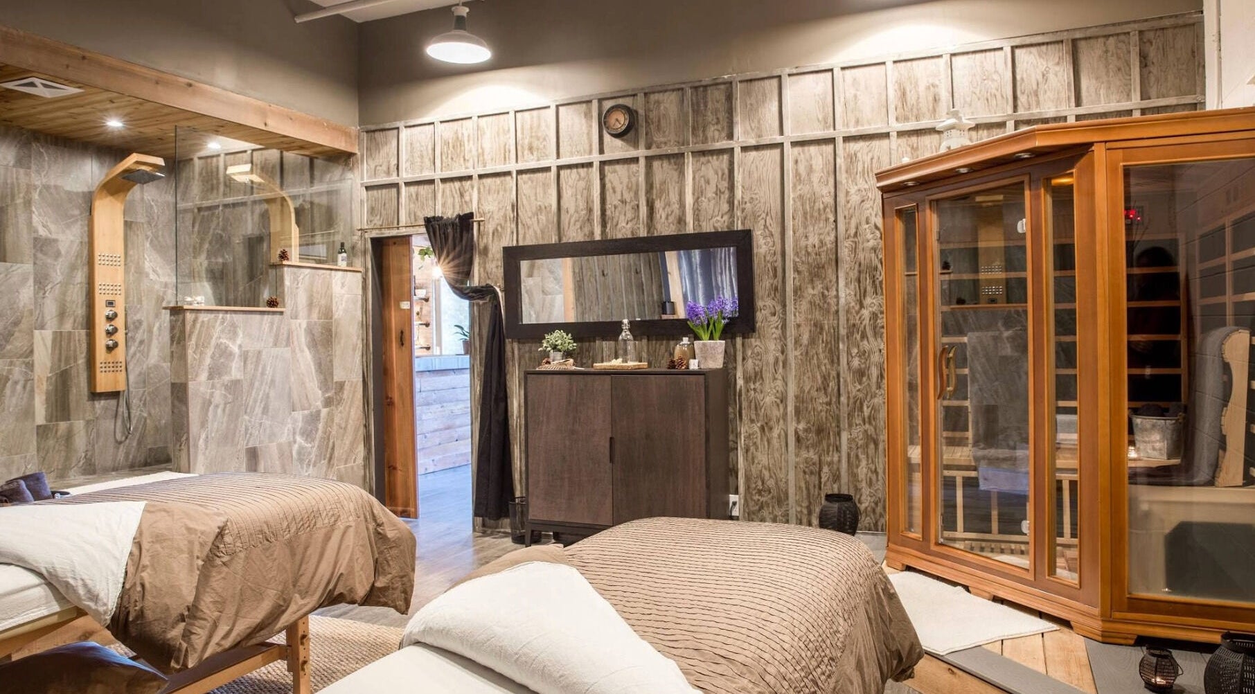 Relaxing spa room at Cedar & Sage Co in Banff, Alberta, CA, featuring massage tables and luxurious decor.