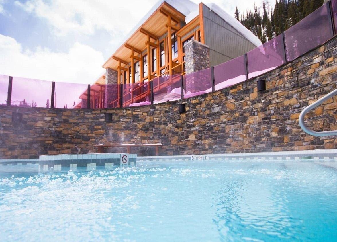 Relaxing outdoor spa at Cedar & Sage Sunshine Village in Banff, Alberta, CA, surrounded by stunning nature.
