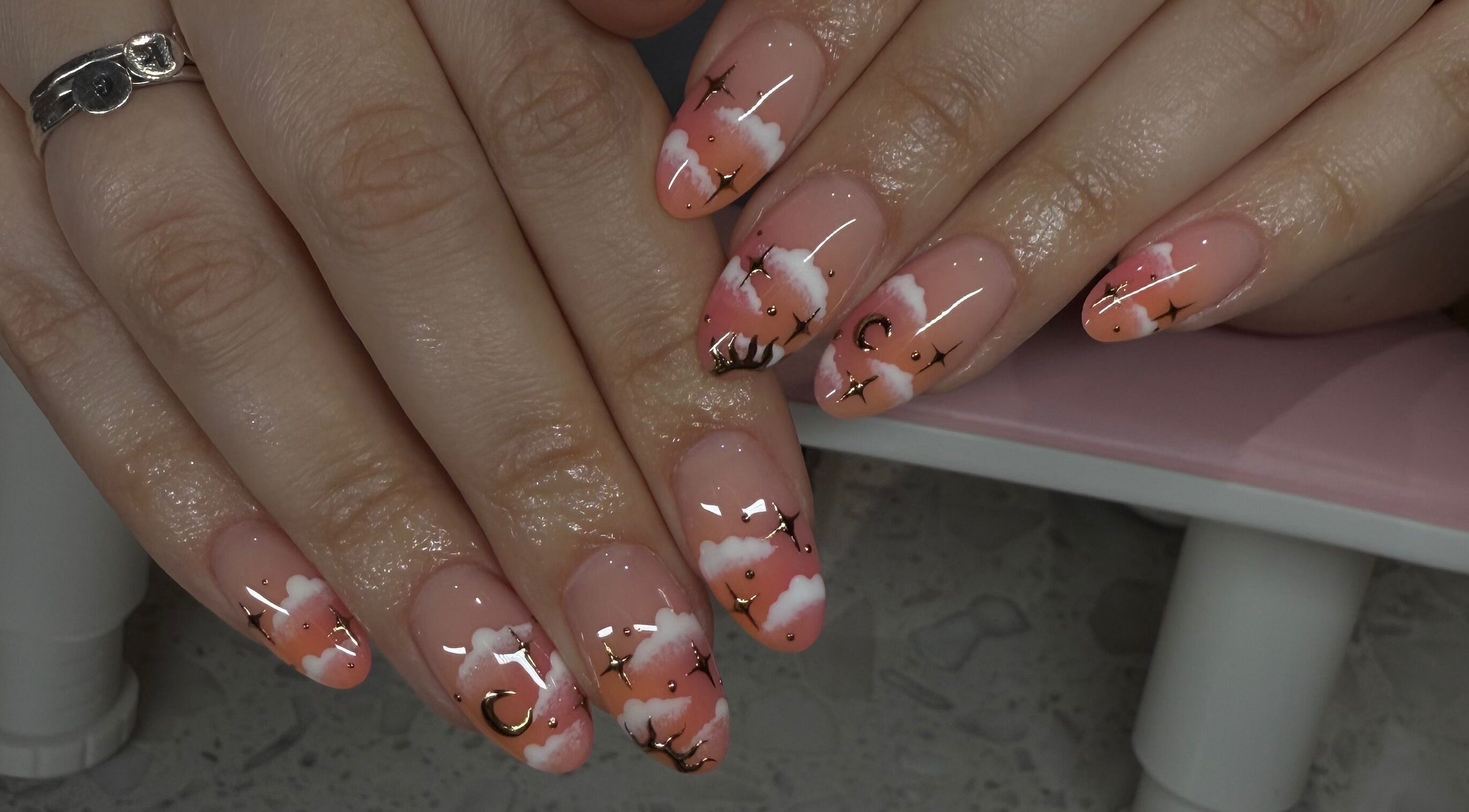 Elegant cloud and star nail art at Pretty Nails Society in Houston, Texas, US.