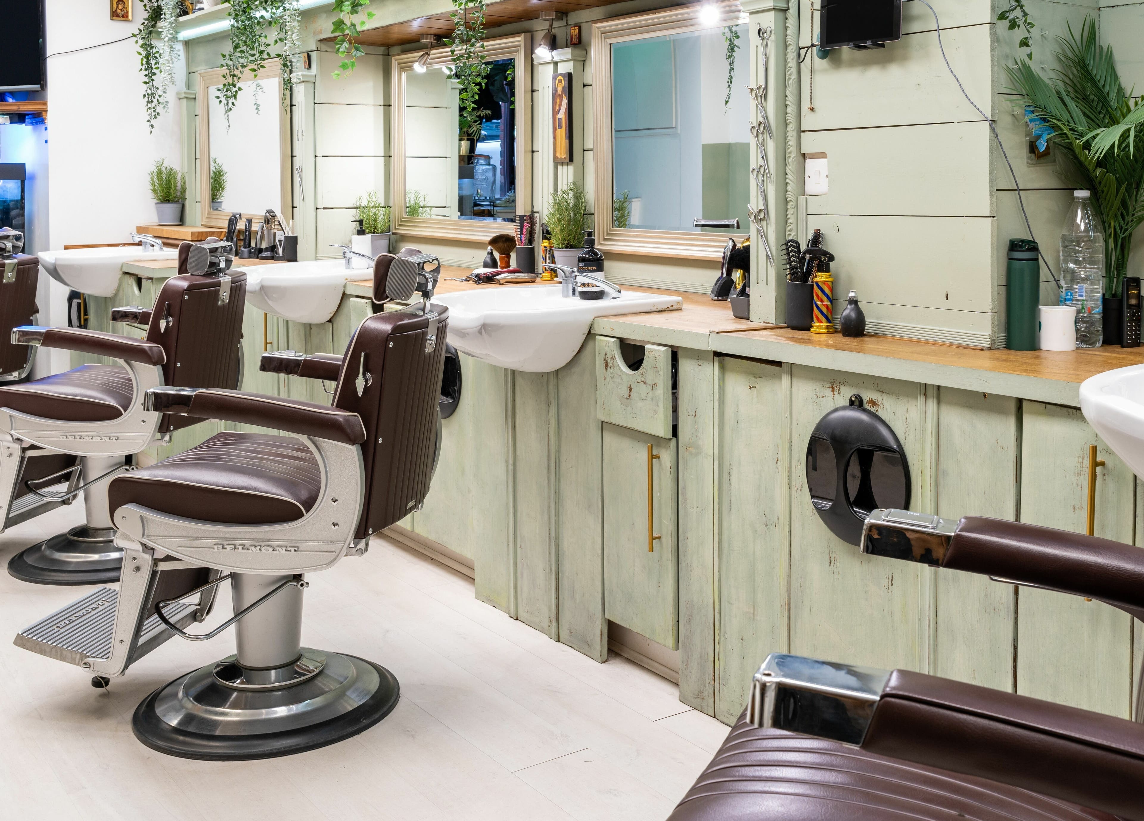 Stylish barber chairs and mirrors at Saints Barbers Crouch End, London, England, GB, creating a modern ambiance.