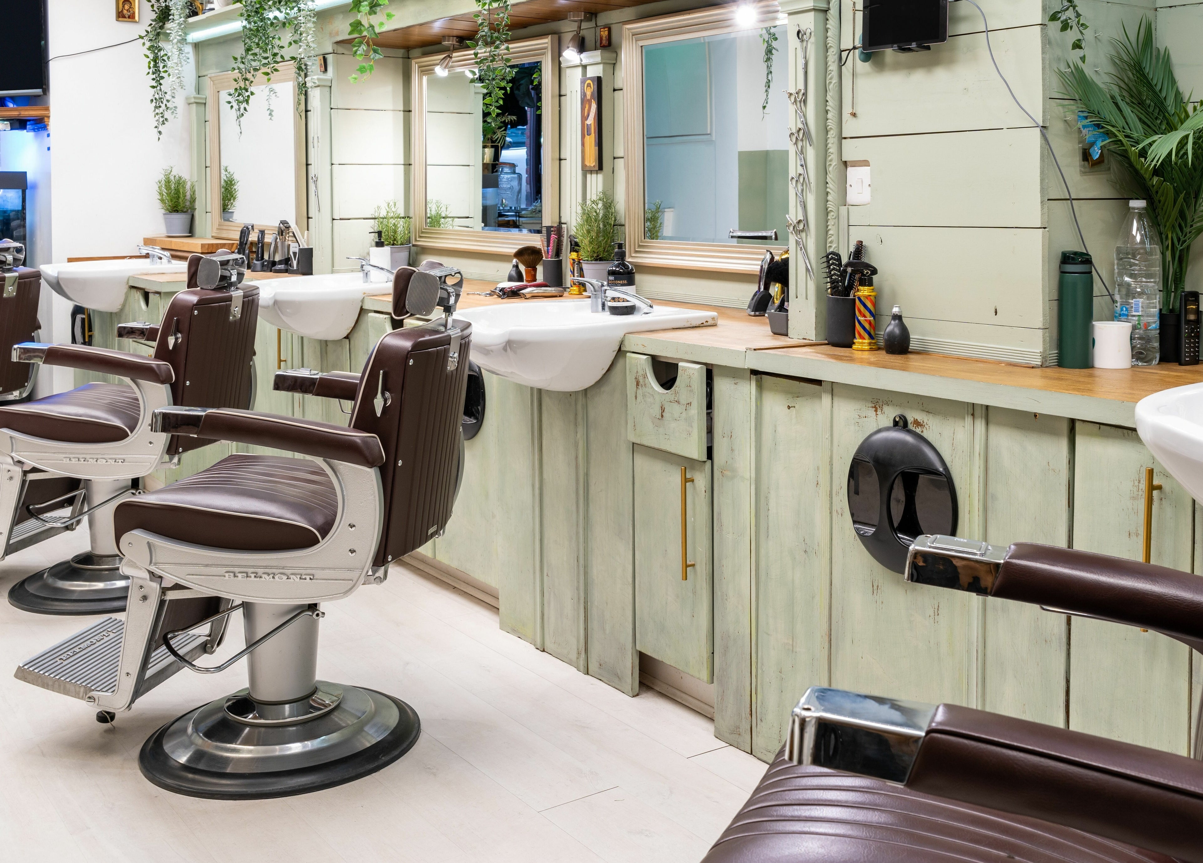 Stylish barber chairs and mirrors at Saints Barbers Crouch End, London, England, GB, creating a modern ambiance.