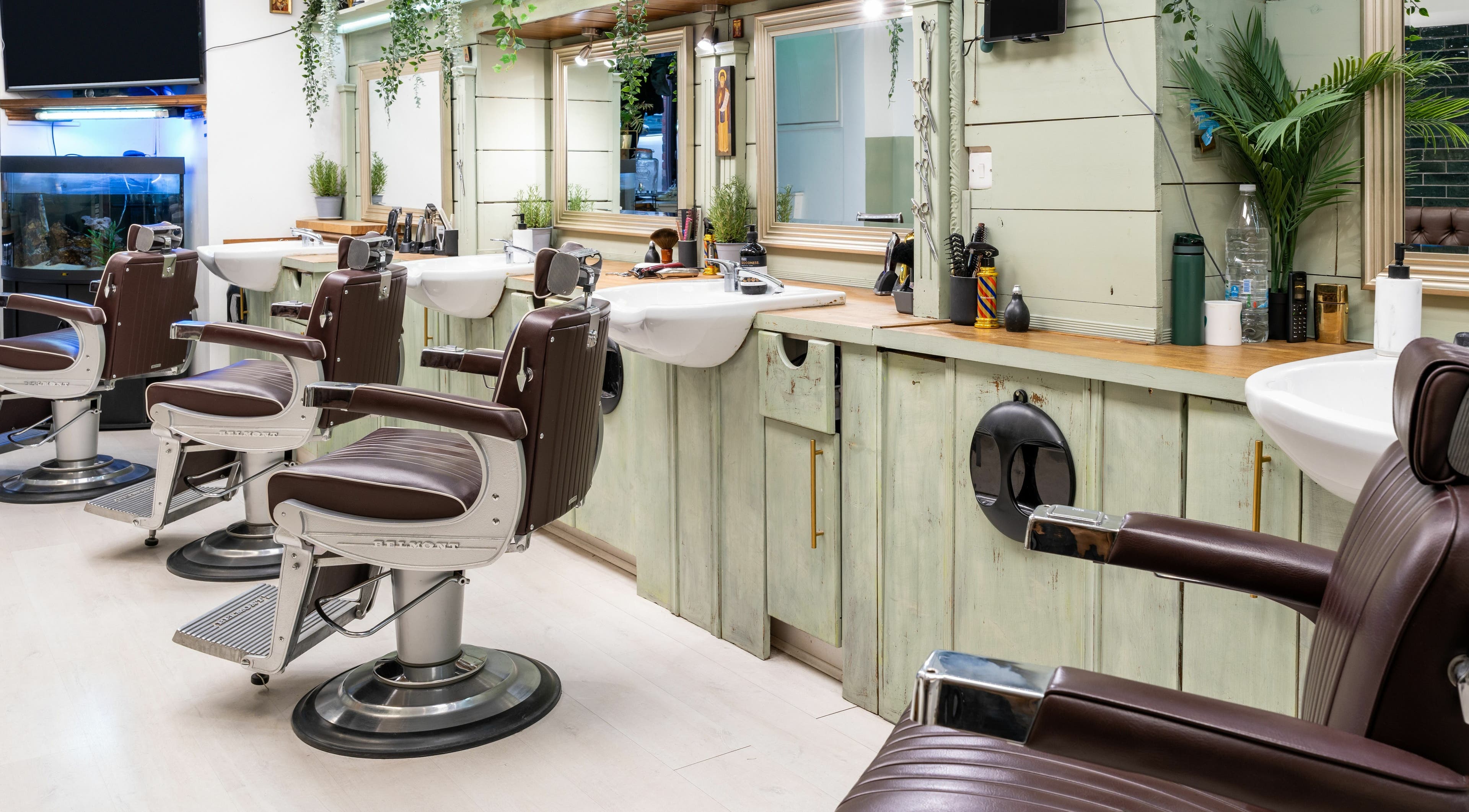 Stylish barber chairs and mirrors at Saints Barbers Crouch End, London, England, GB, creating a modern ambiance.