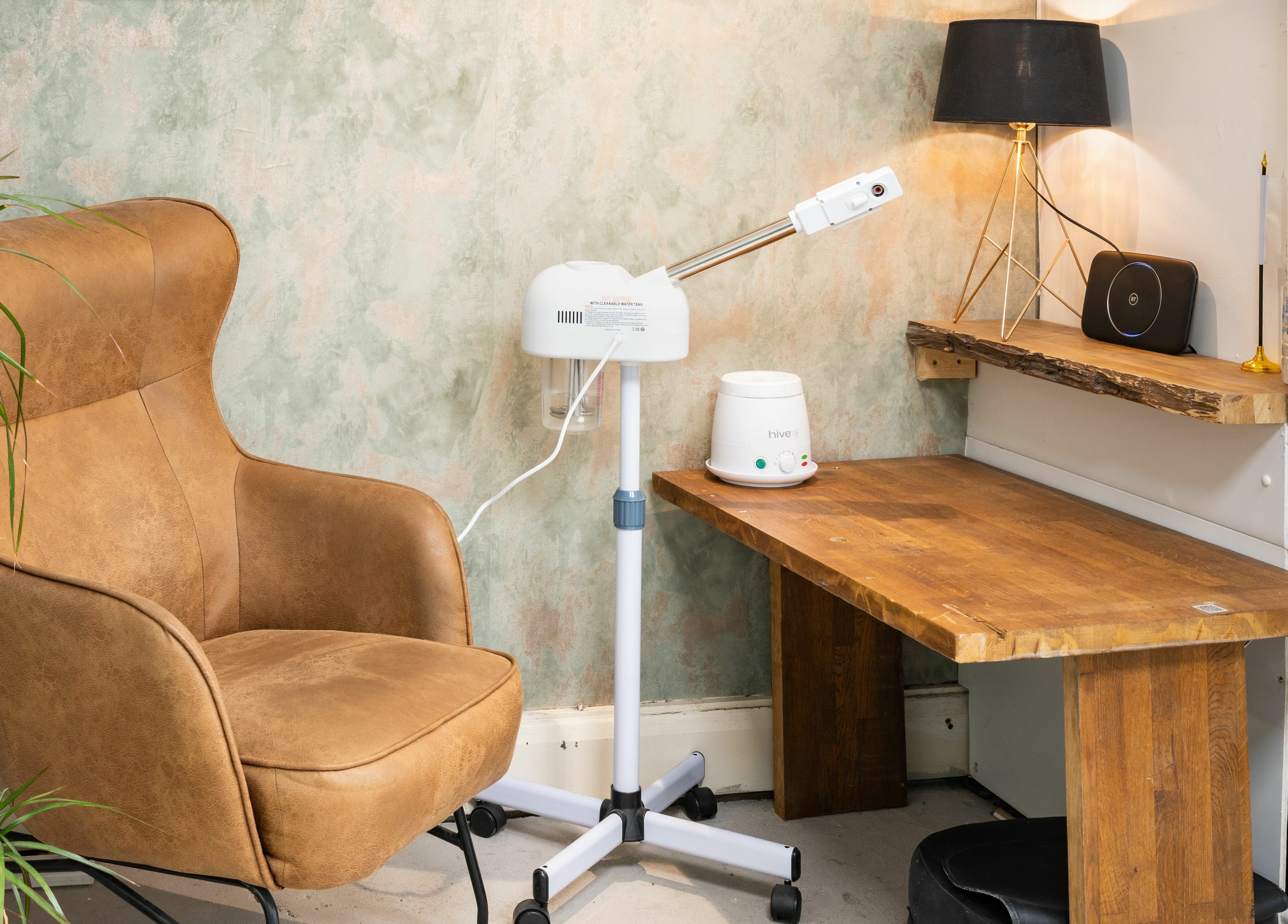 Comfortable beauty corner at Saints Barbers Crouch End, London, England, GB with chair and equipment.