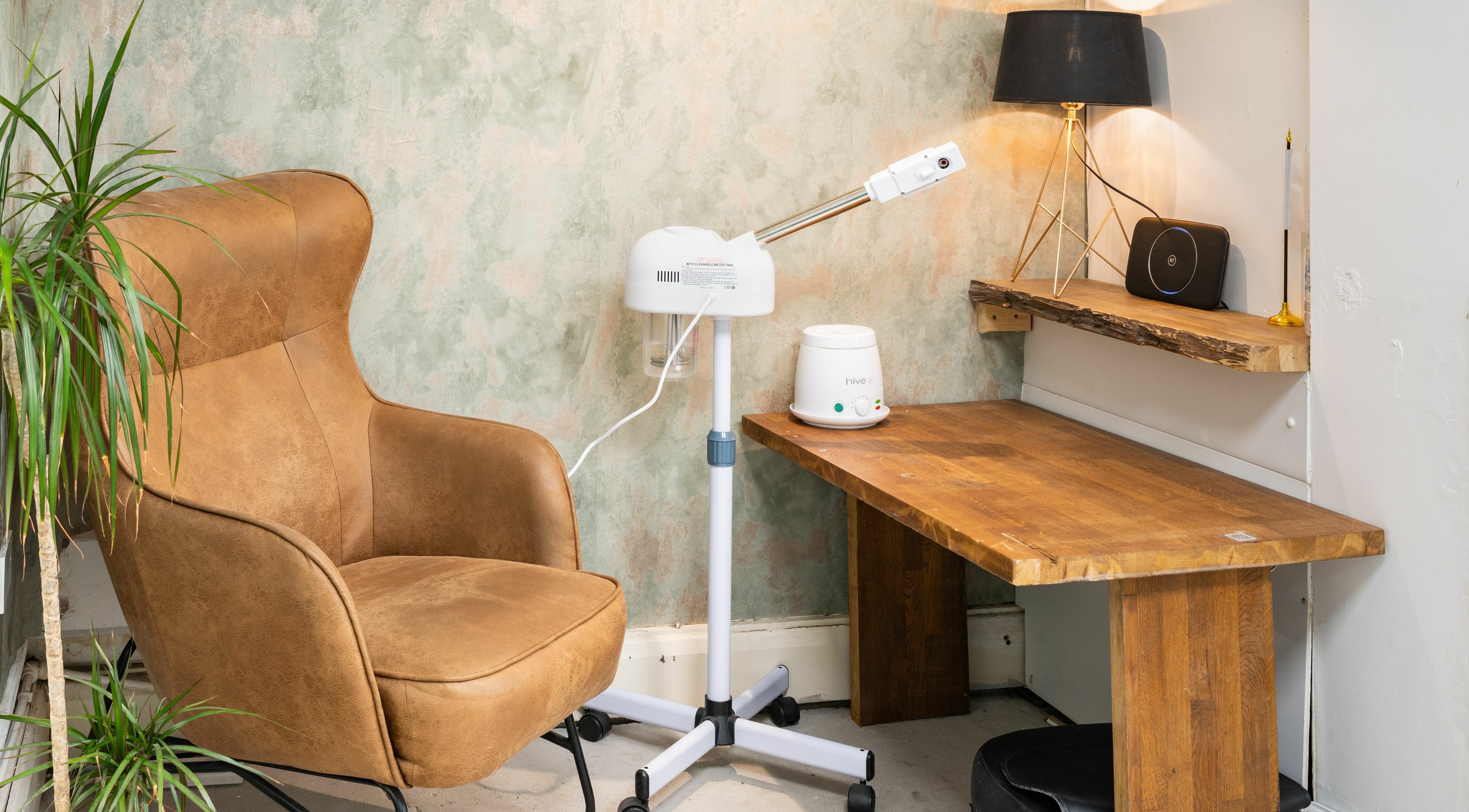 Comfortable beauty corner at Saints Barbers Crouch End, London, England, GB with chair and equipment.