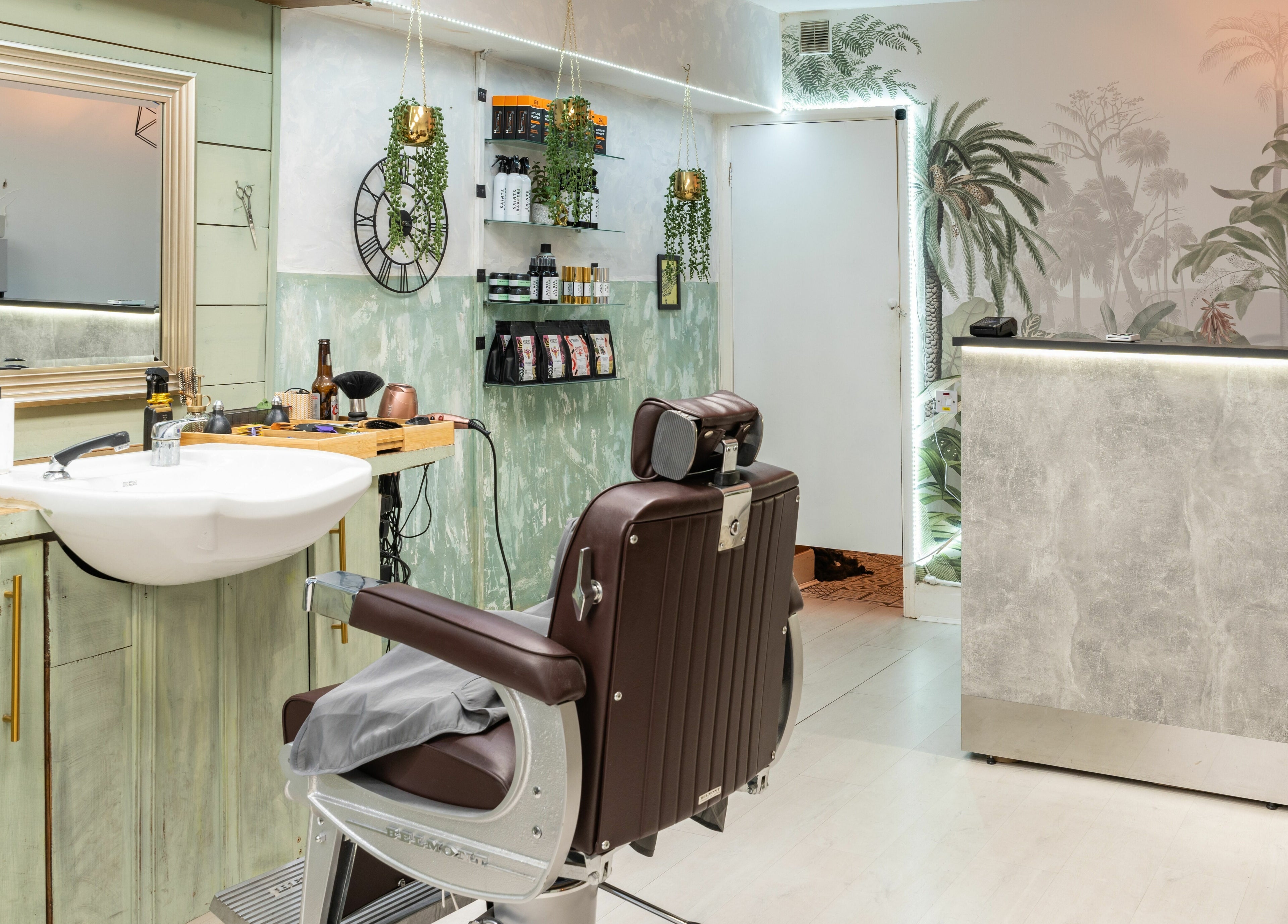 Modern barbershop interior at Saints Barbers Crouch End in London, England, GB featuring chic decor and sleek chair.